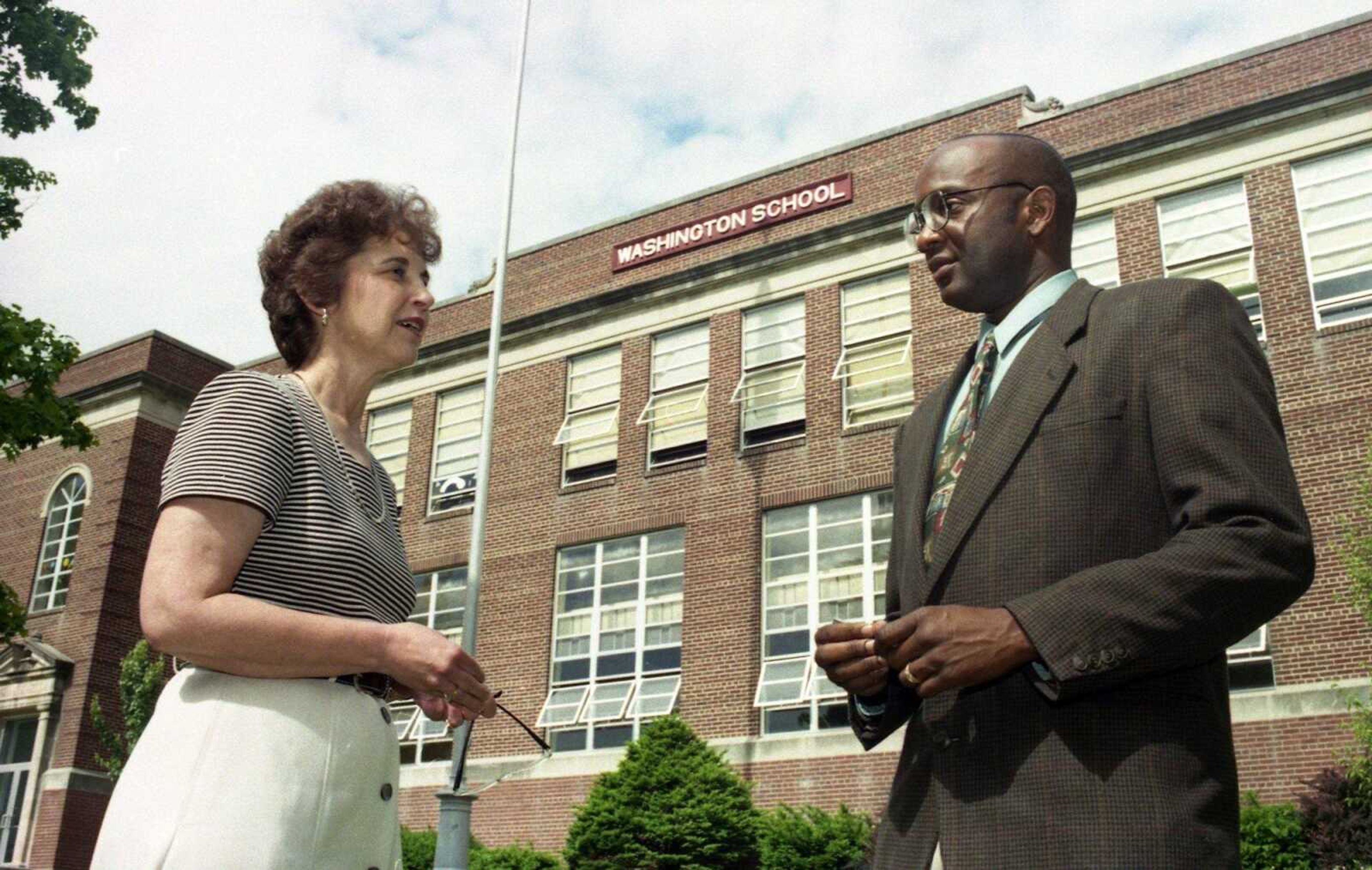 May 18,1997
Principal Barbara Blanchard talked to Frank Ellis outside Washington Elementary School. Ellis will take over leadership of the school.