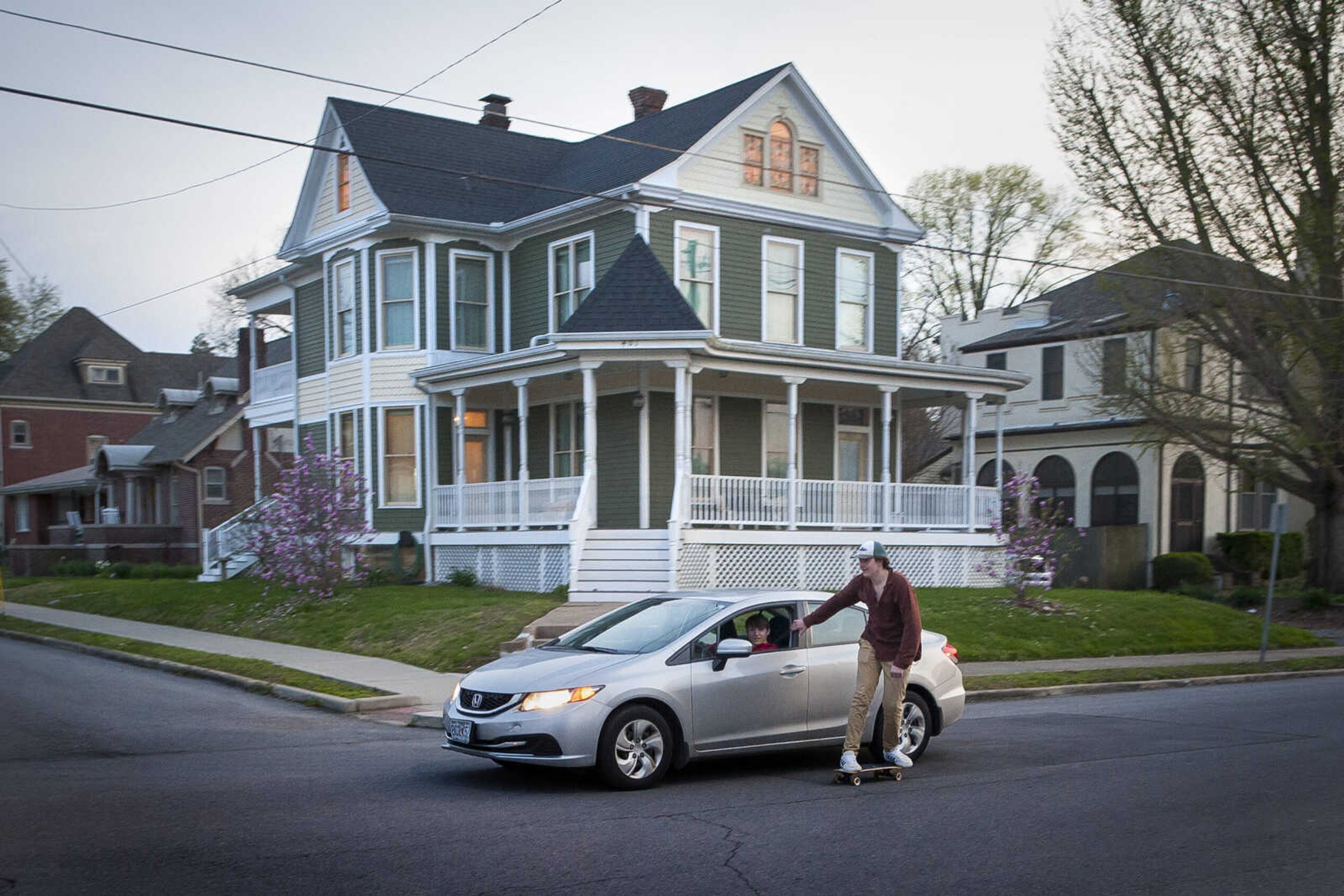 Michael Gibbs tows a skateboarder through the intersection of Themis and North Fountain streets early Wednesday evening, April 1, 2020, in downtown Cape Girardeau.