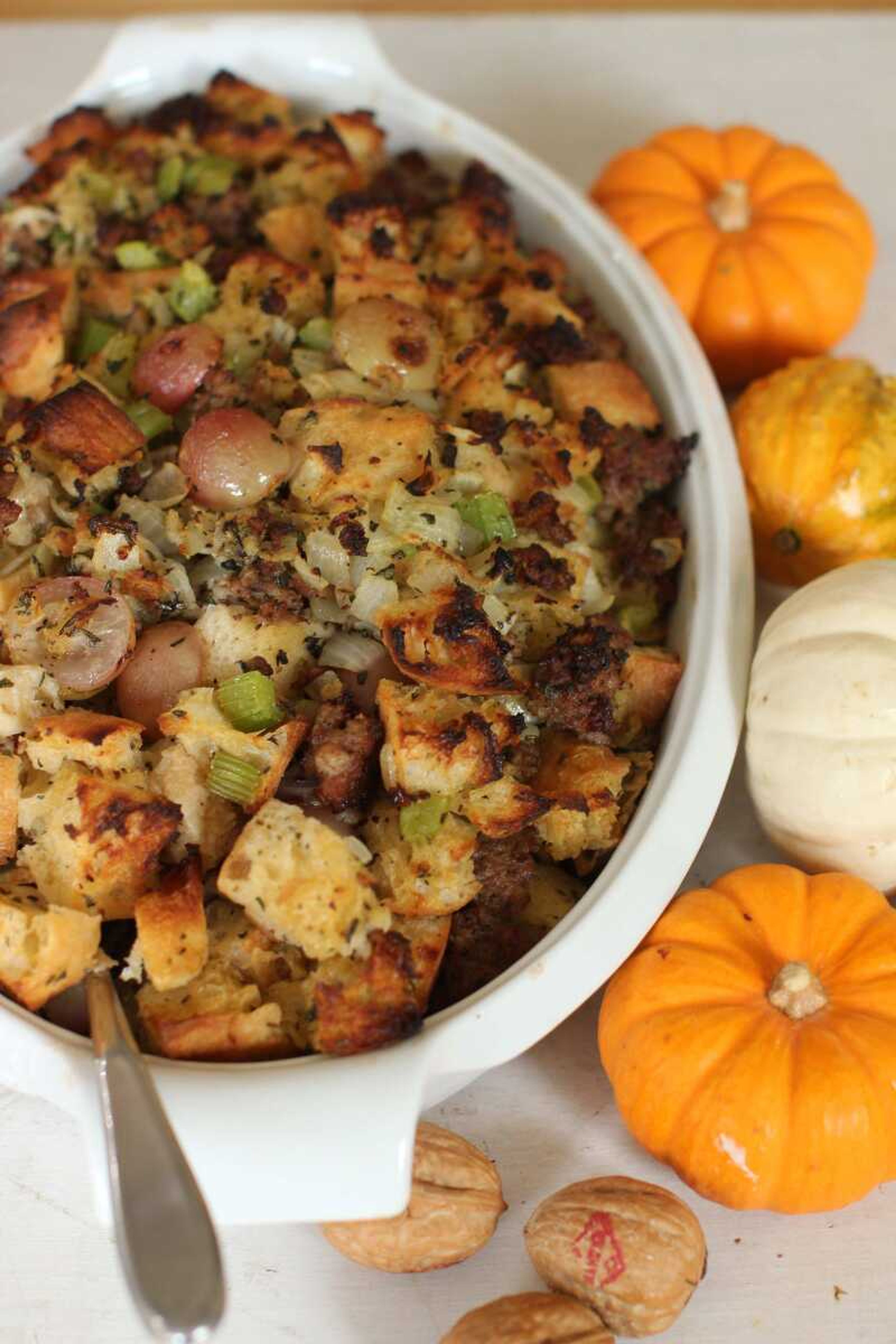 This photo shows sausage and grape Thanksgiving stuffing. Making one giant batch of stuffing allows for some of it to be used to stuff the turkey, while the rest can be put into a well-buttered baking dish. (AP Photo/Matthew Mead)