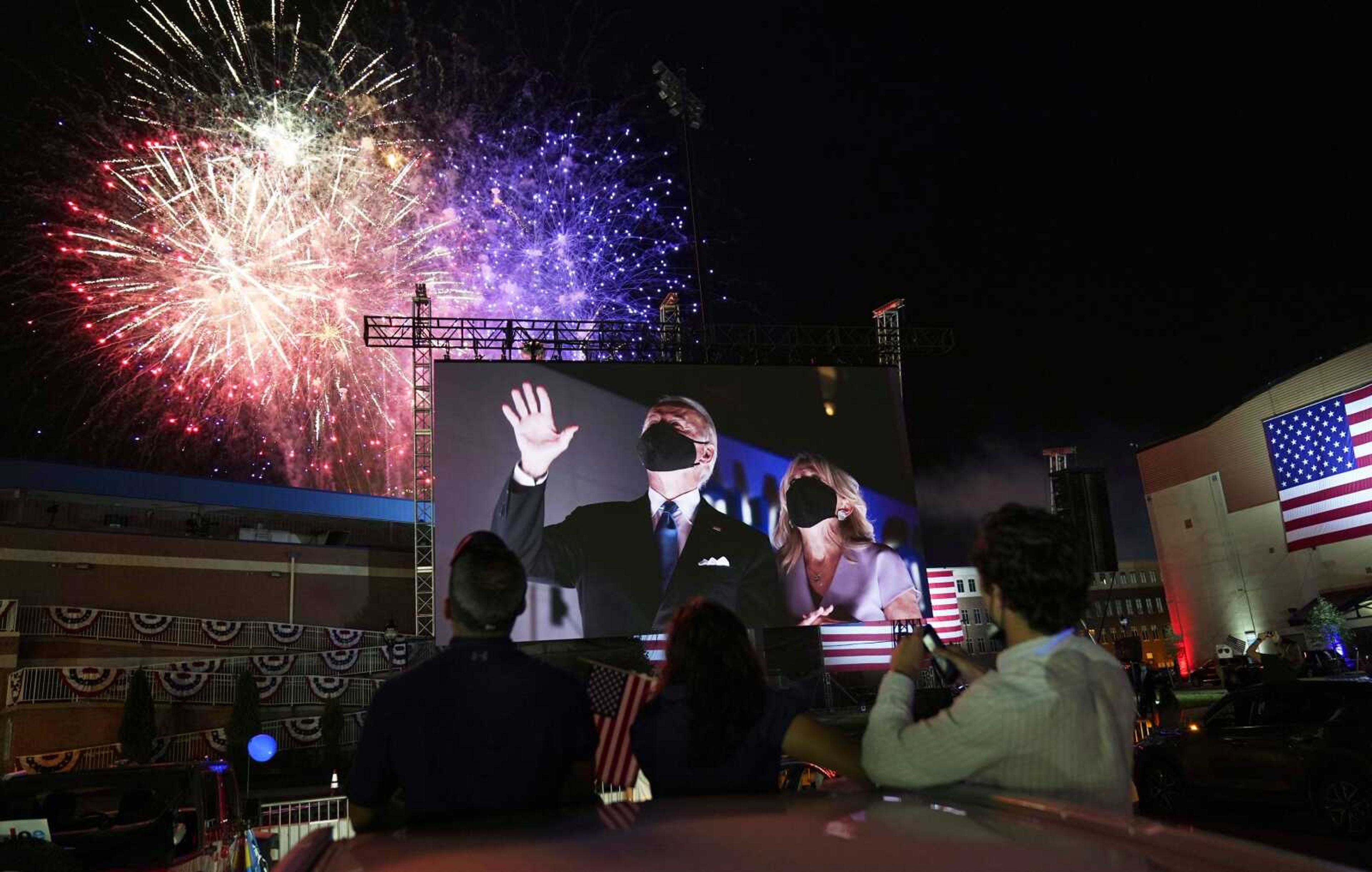 Democratic presidential candidate former Vice President Joe Biden, and his wife, Jill Biden, are shown on large screens outside the venue where Biden spoke at the conclusion of the final day of the Democratic National Convention.