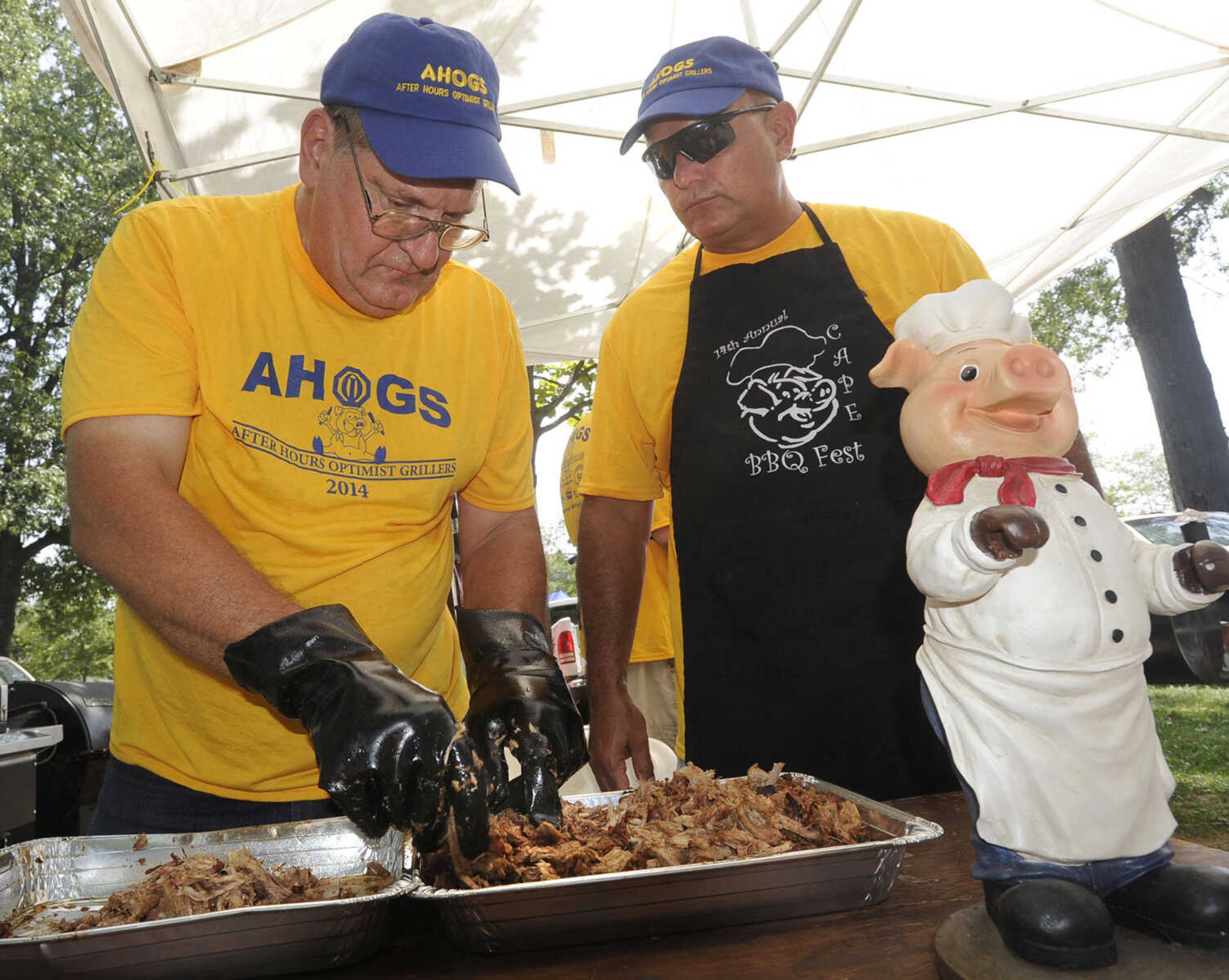 FRED LYNCH ~ flynch@semissourian.com
Robert Blasiney, left, and David Diveley with the After Hours Optimist Grillers team prepare pork butt for judging Saturday, Aug. 23, 2014 at the Cape BBQ Fest in Arena Park.