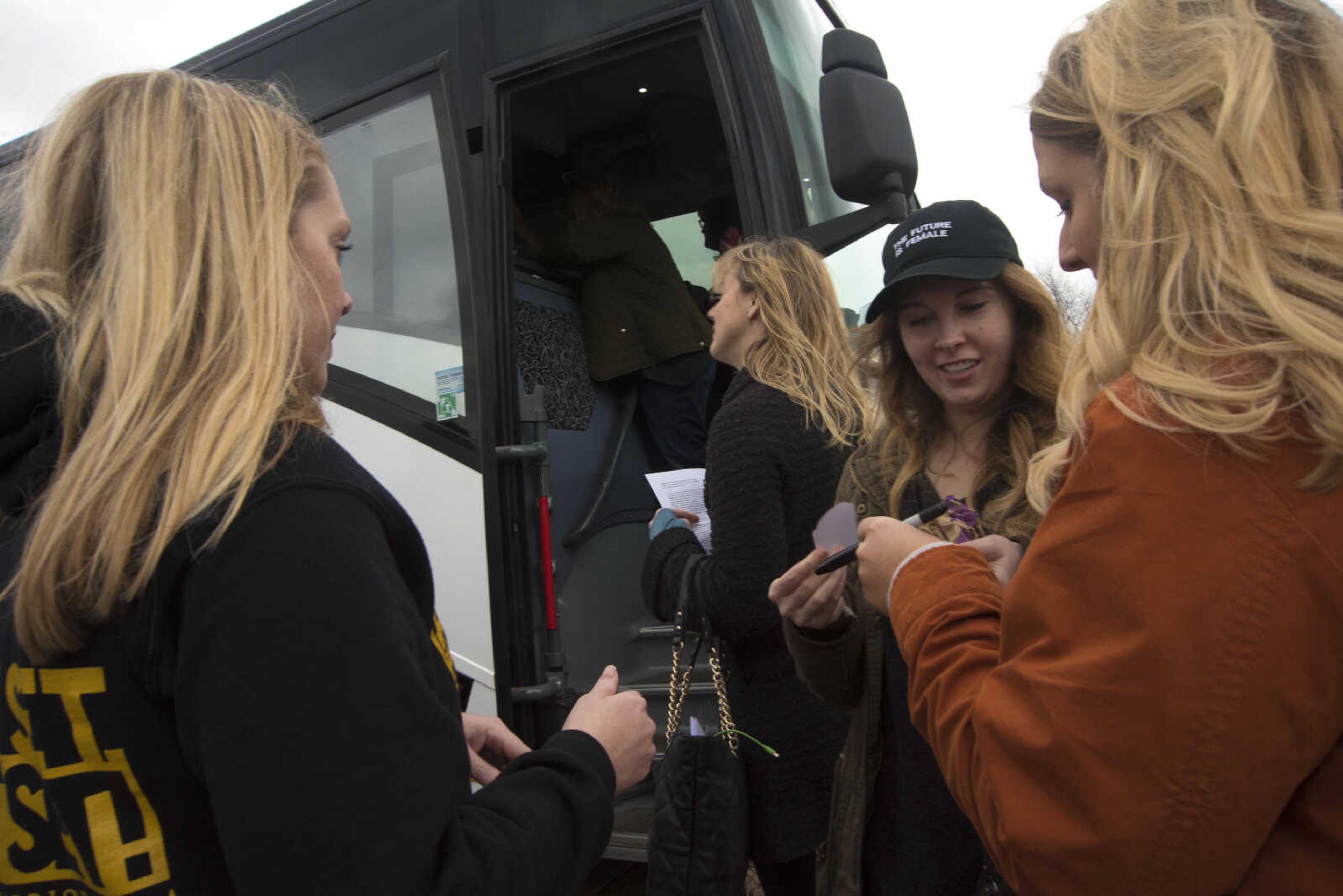 Protestors get ready to travel to Washington D.C. to participate in the Women's March on Saturday as they get ready to leave Friday, Jan. 20, 2017 in the Scully Building parking lot at Southeast Missouri State University in Cape Girardeau.