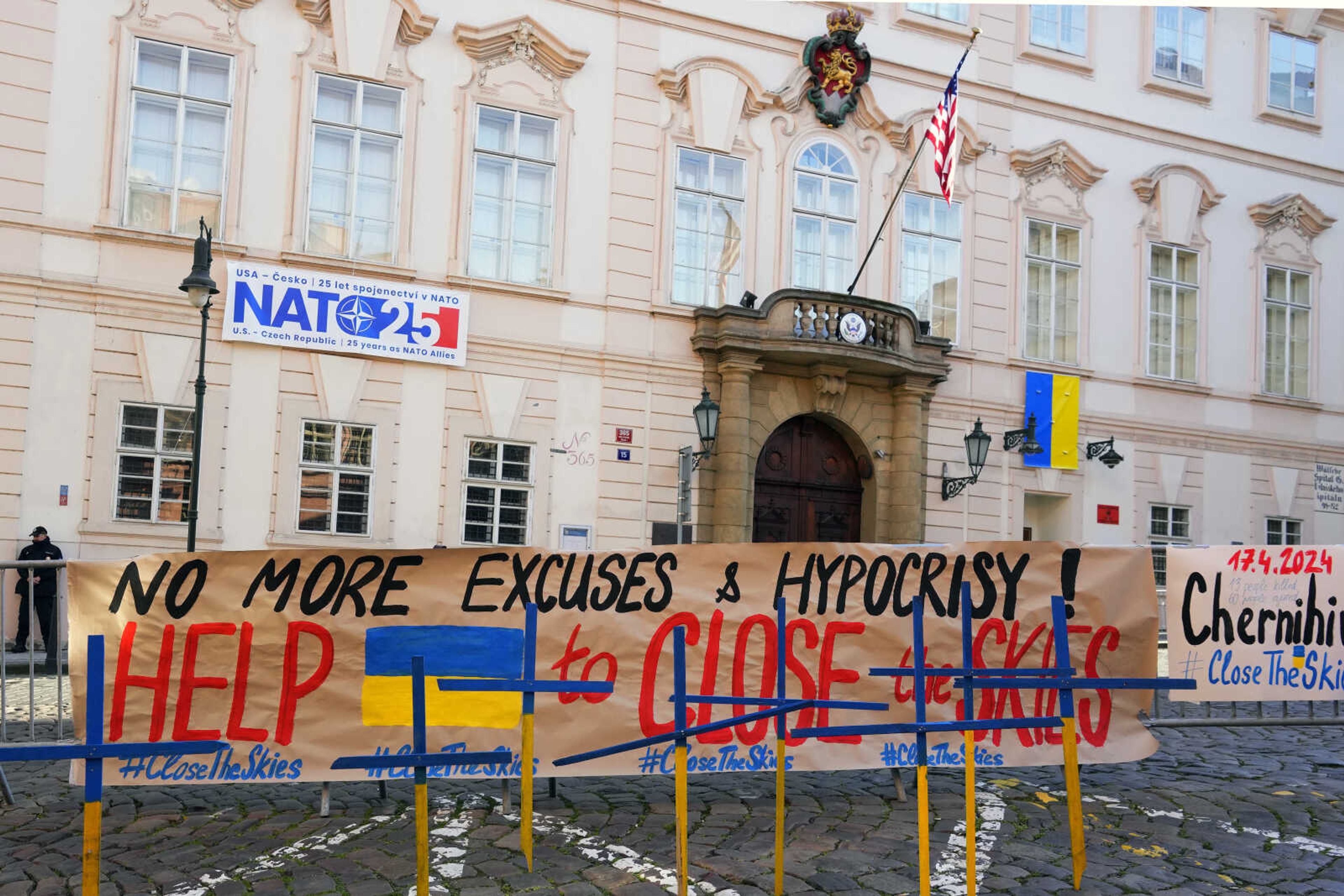 Crosses painted in Ukrainian colours are placed in front of the US embassy during a protest in Prague, Czech Republic, Wednesday, April 17, 2024. People gathered in Prague to demand, from the West, supply of missile defense systems for Ukraine, so it can help against the Russian missiles, in same way as the West helped Israel in recent Iranian attacks. (AP Photo/Petr David Josek)