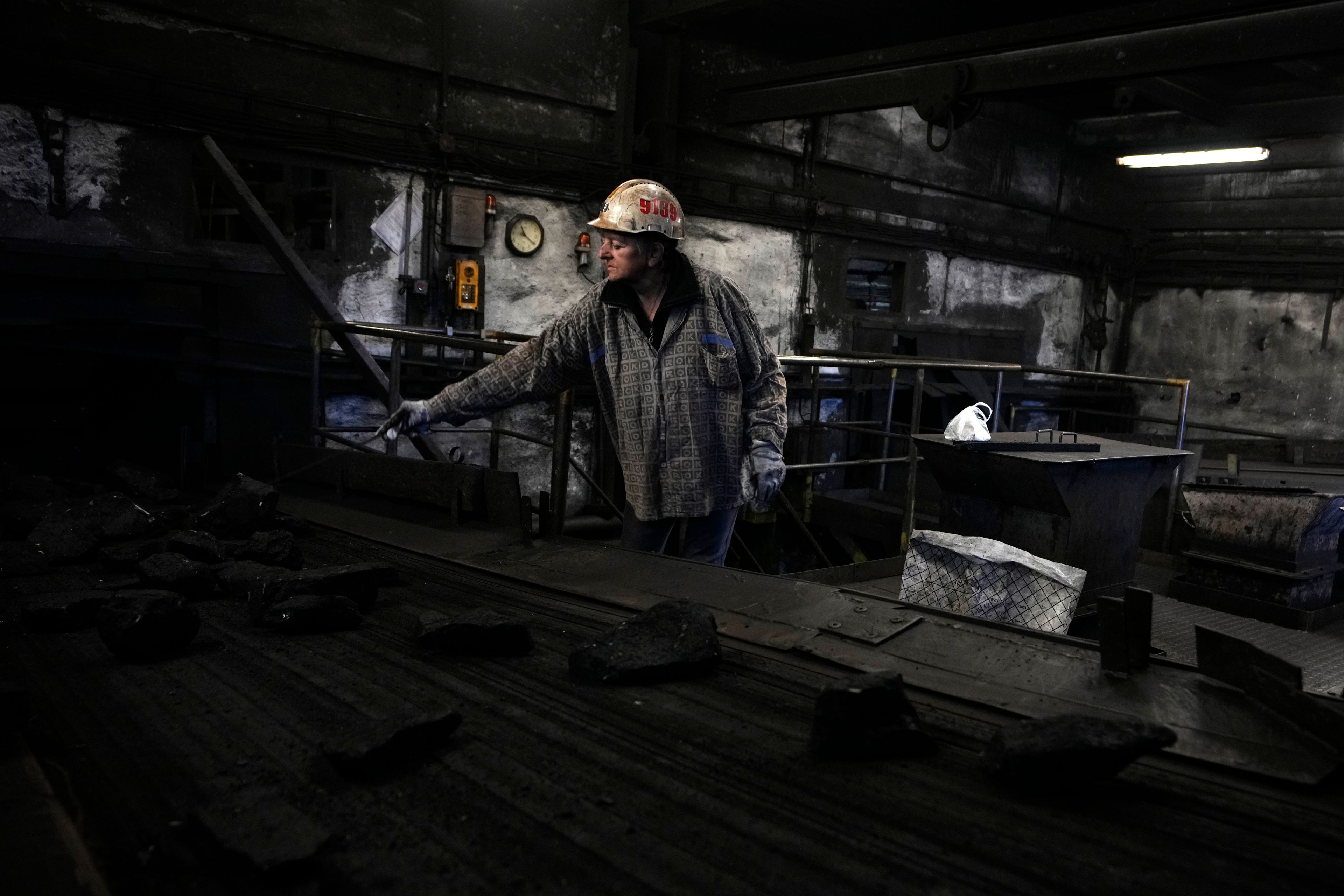 A worker sorts coal at the CSM coal mine in Stonava, Czech Republic, Monday, Oct. 14, 2024. (AP Photo/Petr David Josek)