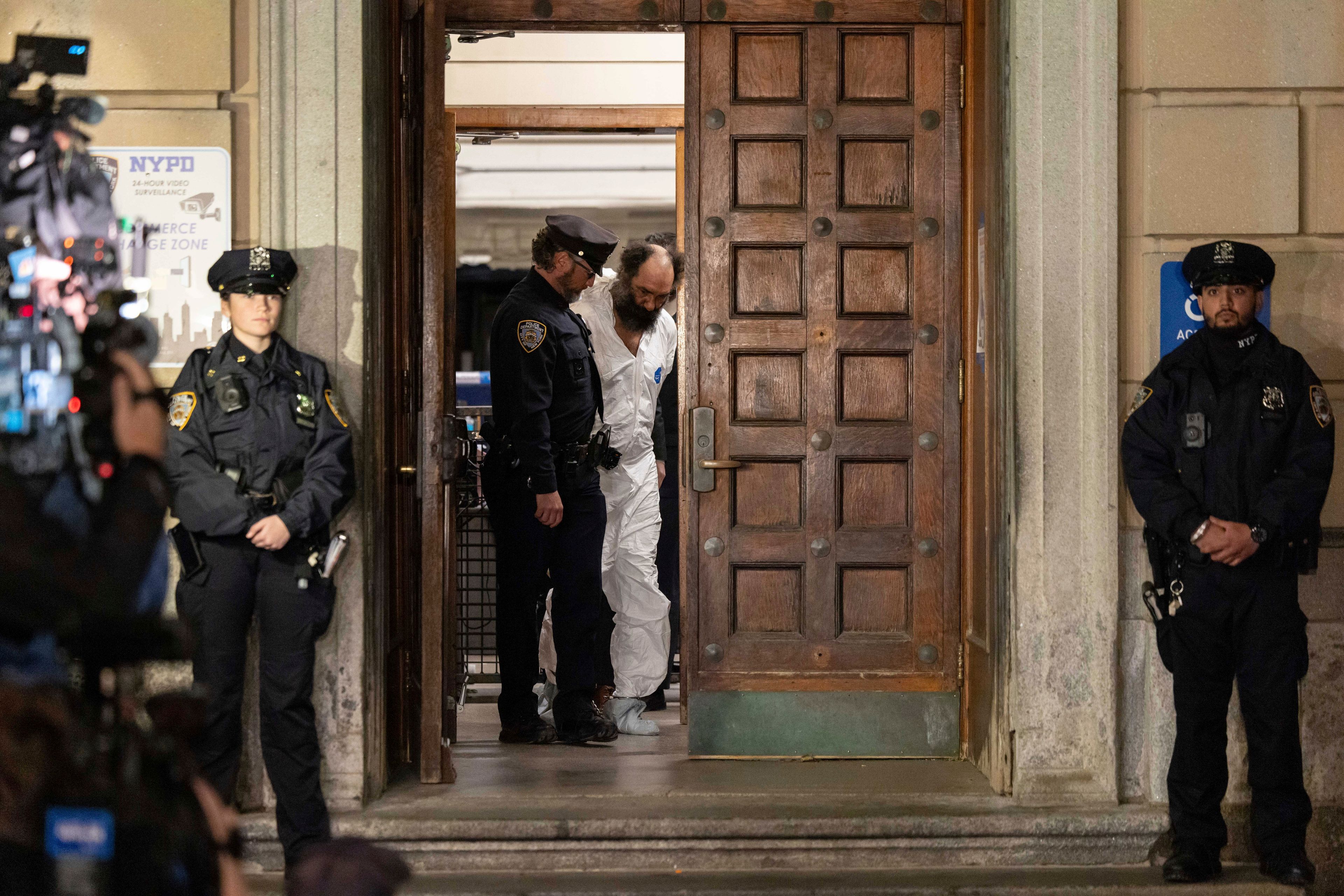 Ramon Rivera, a suspect arrested after multiple people were stabbed early Monday, is escorted out by NYPD officers at the NYPD 10th Precinct in New York, Monday, Nov. 18, 2024. (AP Photo/Yuki Iwamura)