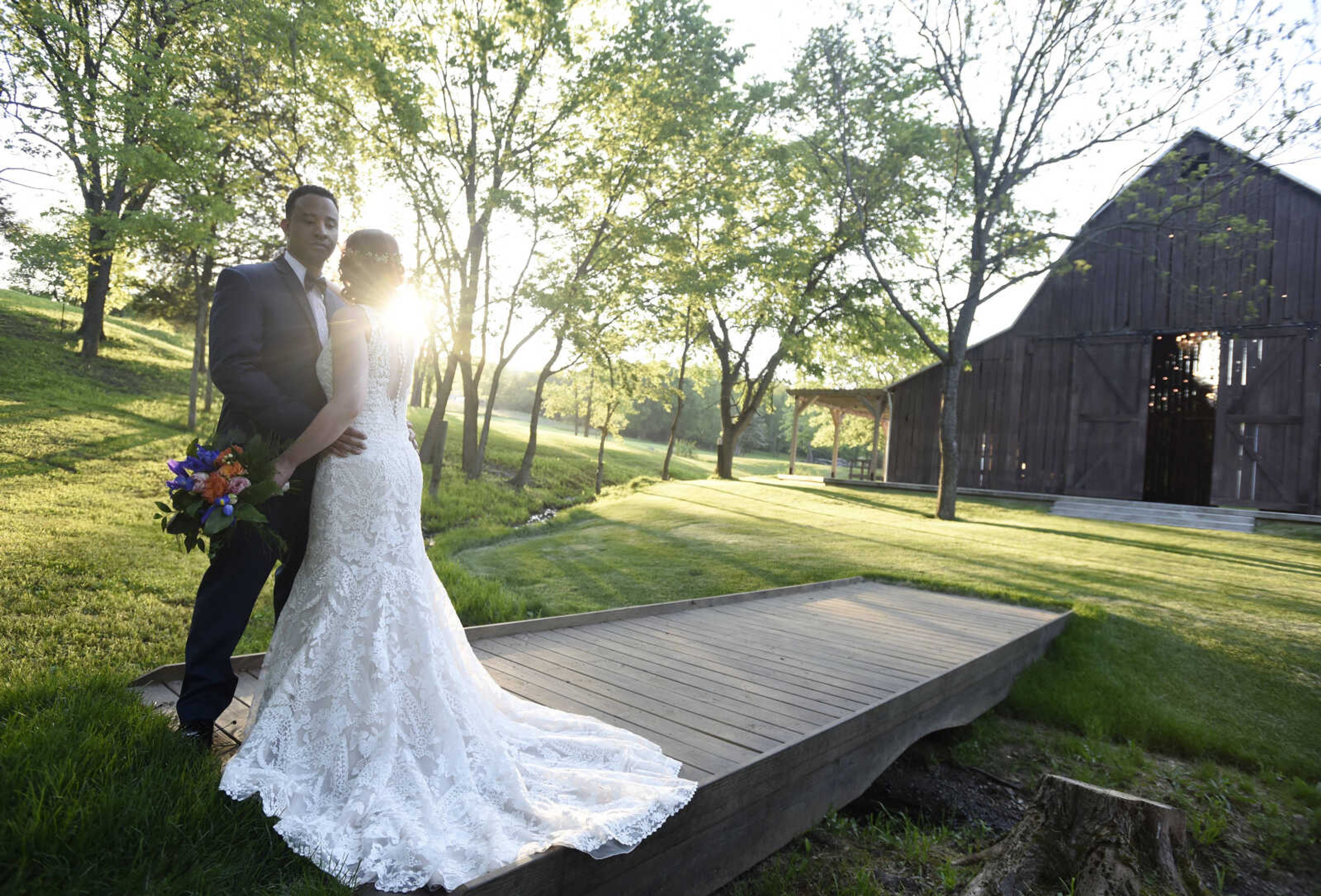 This Eddy K dress is a fit and flare, ivory on champagne colored gown. It has heavily embroidered symmetrical lace over velure tulle, with a detailed illusion back. Available at Ann-Louise Bridal in Jackson. 

Wedding suits courtesy of Jim's Formal Wear and available at Garber's Men's Wear in Cape Girardeau.