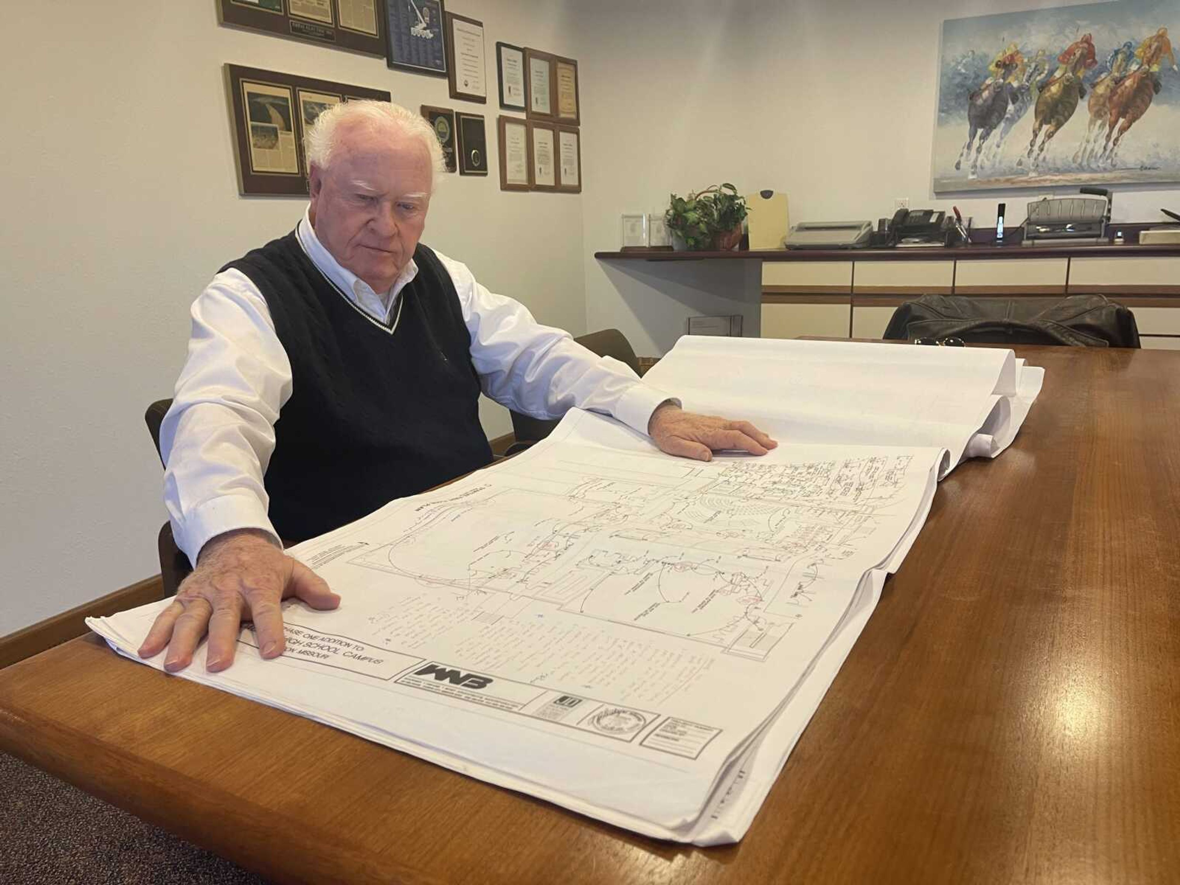 Danny Miller, chief operations officer of Total Electric in Farmington, Missouri, looks over plans from a 2006 Jackson School District expansion project. The red ink on the page contains problems with the plans identified by Miller's employees. Those issues are at the heart of a long-running lawsuit between the school district and Miller.