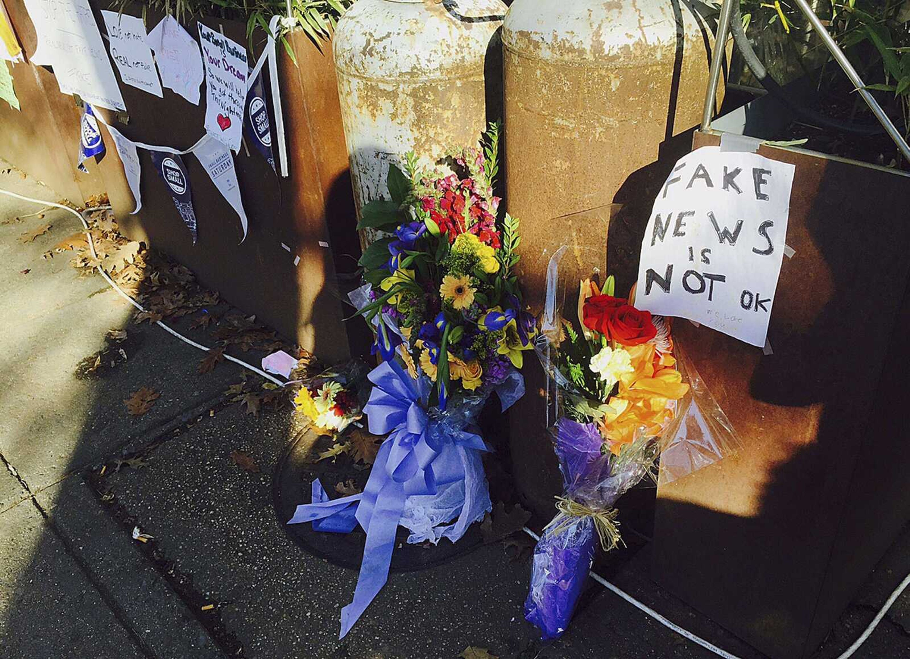 Flowers and notes left Friday by well-wishers outside Comet Ping Pong, a pizza restaurant in northwest Washington, D.C., are shown, where a North Carolina man fired an assault rifle several times as he tried to "self-investigate" the conspiracy theory known in the Twitterverse as "Pizzagate."