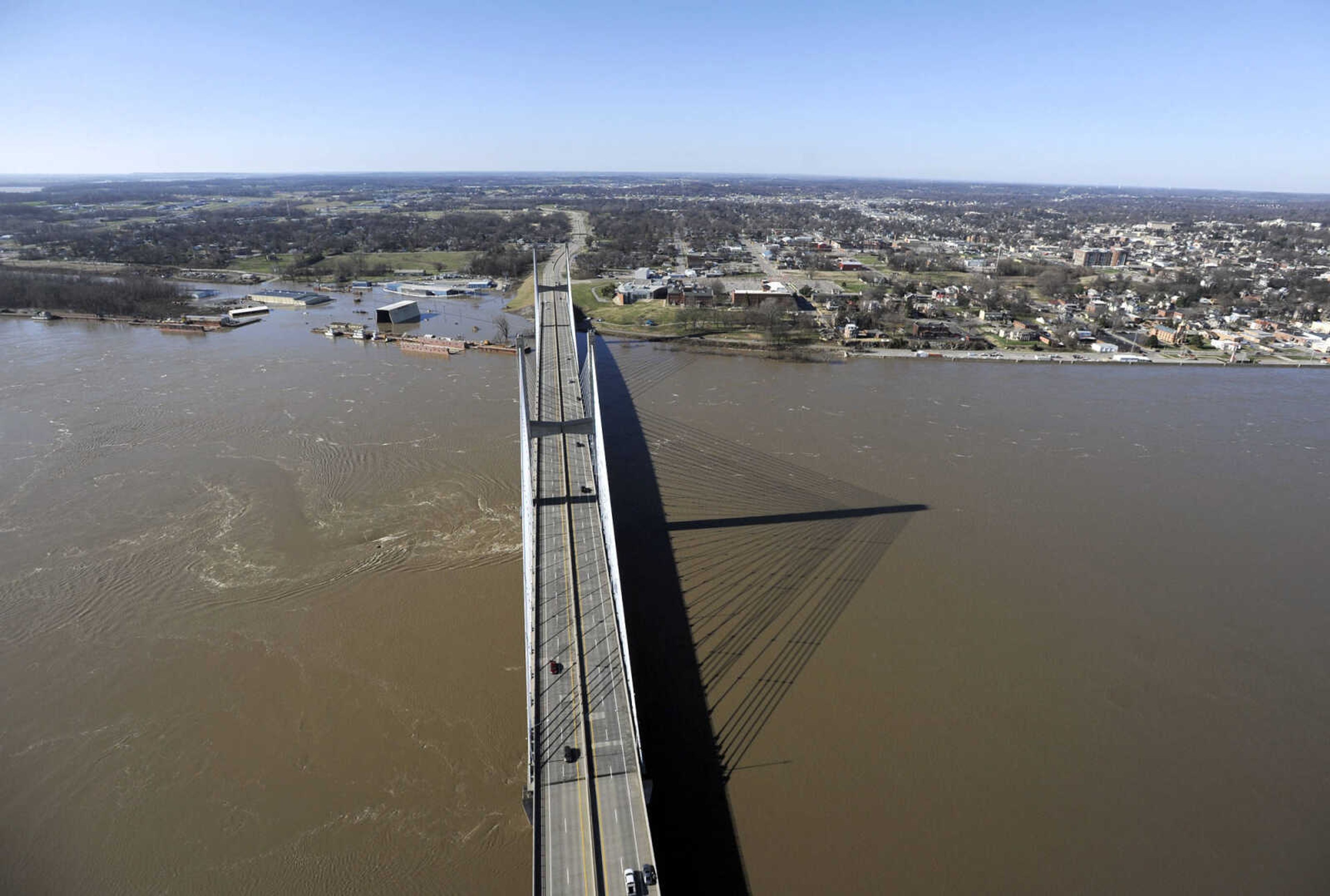 LAURA SIMON ~ lsimon@semissourian.com

The swollen Mississippi River is seen flowing under the Bill Emerson Memorial Bridge in Cape Girardeau, Saturday, Jan. 2, 2016.