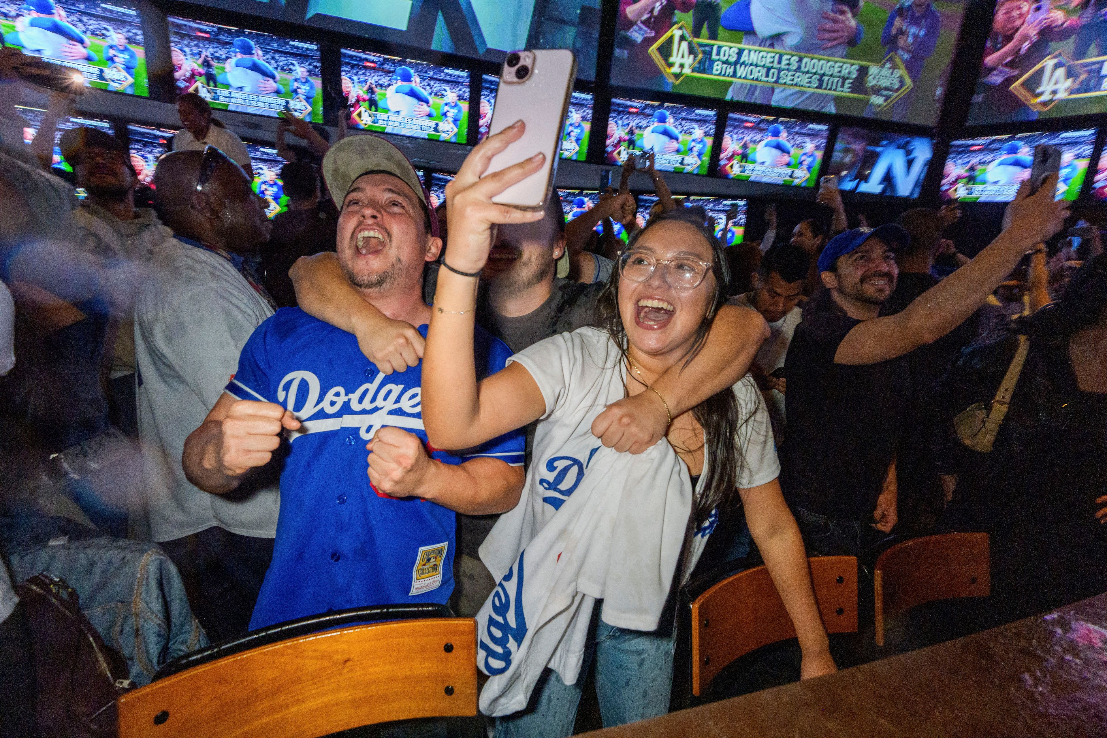 Fans celebrate after the Los Angeles Dodgers defeated the New York Yankees to win the baseball World Series Wednesday, Oct. 30, 2024, in Los Angeles. (AP Photo/Damian Dovarganes)