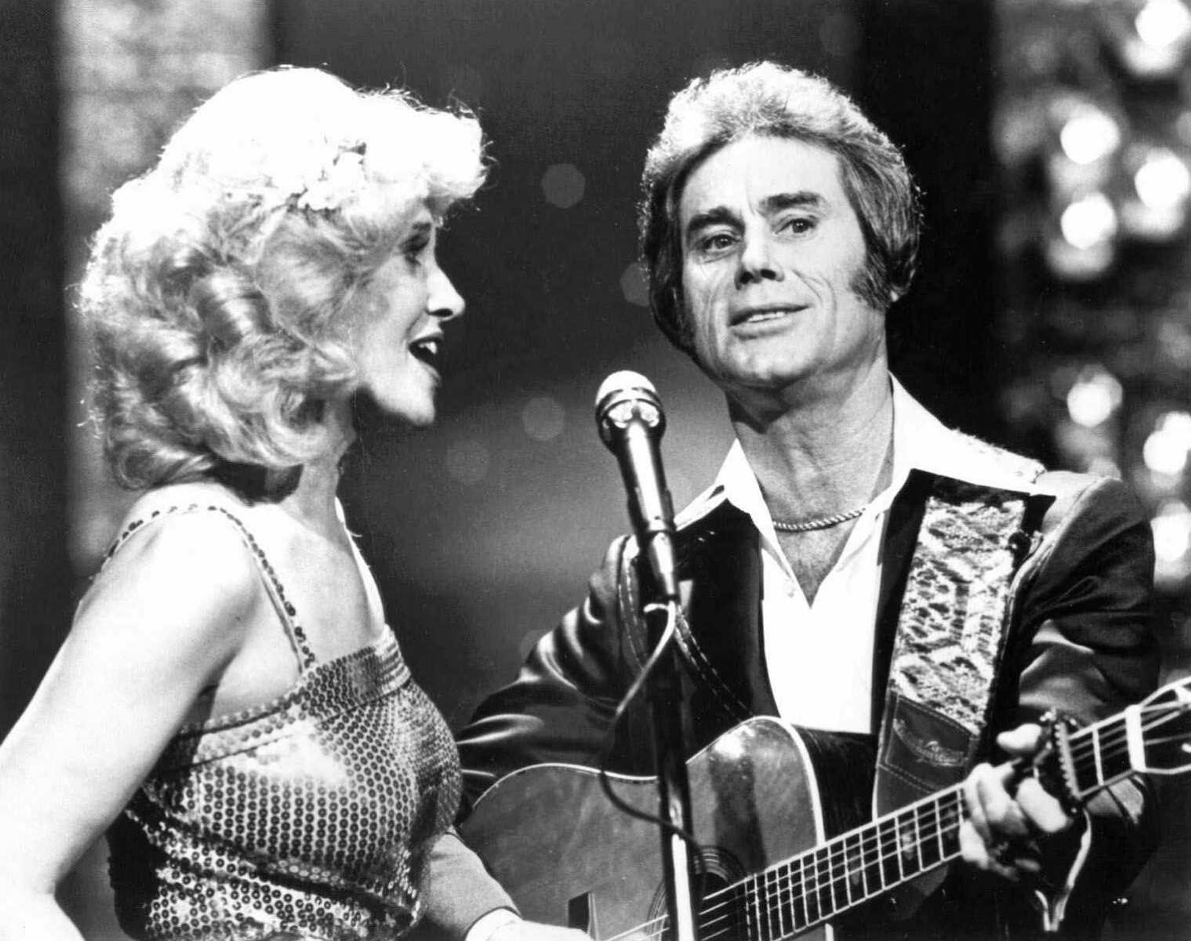 FILE - In this undated photo, Tammy Wynette, left, sings with George Jones in Nashville.   Jones, the peerless, hard-living country singer who recorded dozens of hits about good times and regrets and peaked with the heartbreaking classic "He Stopped Loving Her Today," has died. He was 81. Jones died Friday, April 26, 2013 at Vanderbilt University Medical Center in Nashville after being hospitalized with fever and irregular blood pressure, according to his publicist Kirt Webster. (AP Photo/The Tennessean)