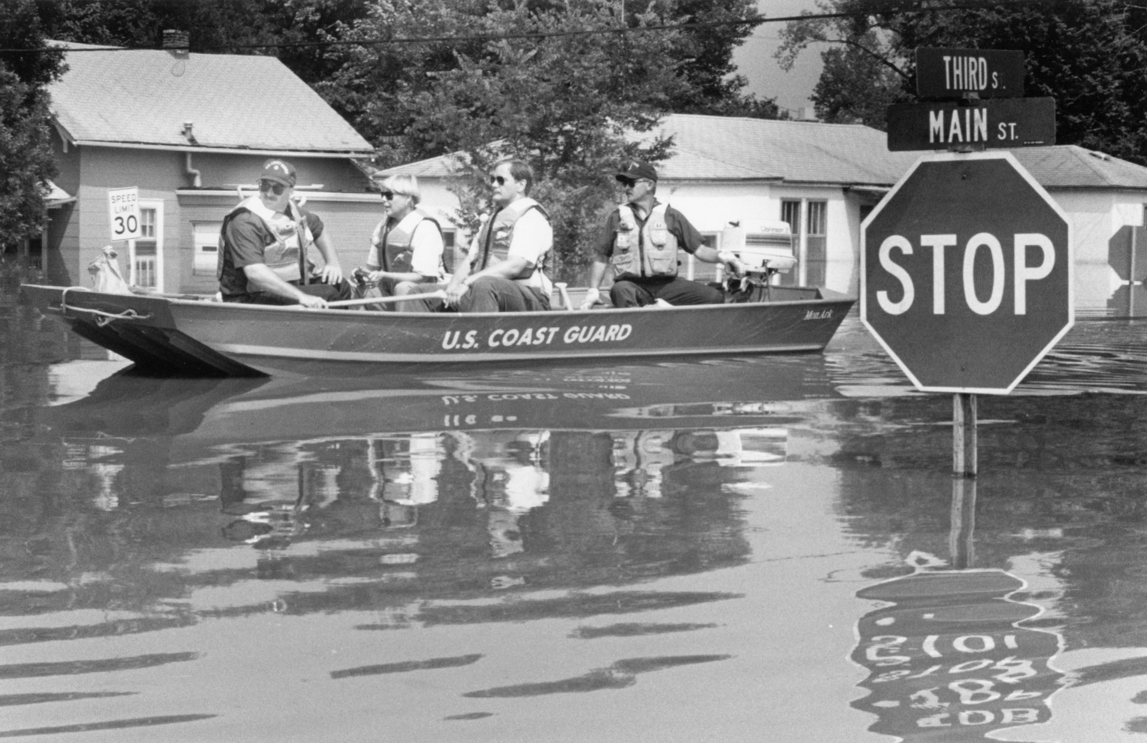 Coast Guard Petty Officer Mike Sanders, left, and Petty Officer Tommy Wright, both of the Chattanooga, Tennessee, Coast Guard Reserve Unit, escort Cape Girardeau County Health Department administrator Charlotte Craig and Howard Courtney, Cape County Health Department environmental sanitarian, Monday, Aug. 9, 1993, in Red Star District. They were checking with residents who might have health concerns because of flooding. This was the day after the Mississippi River crested at 48.49 feet, a new record that was, in turn, supplanted in 2016.