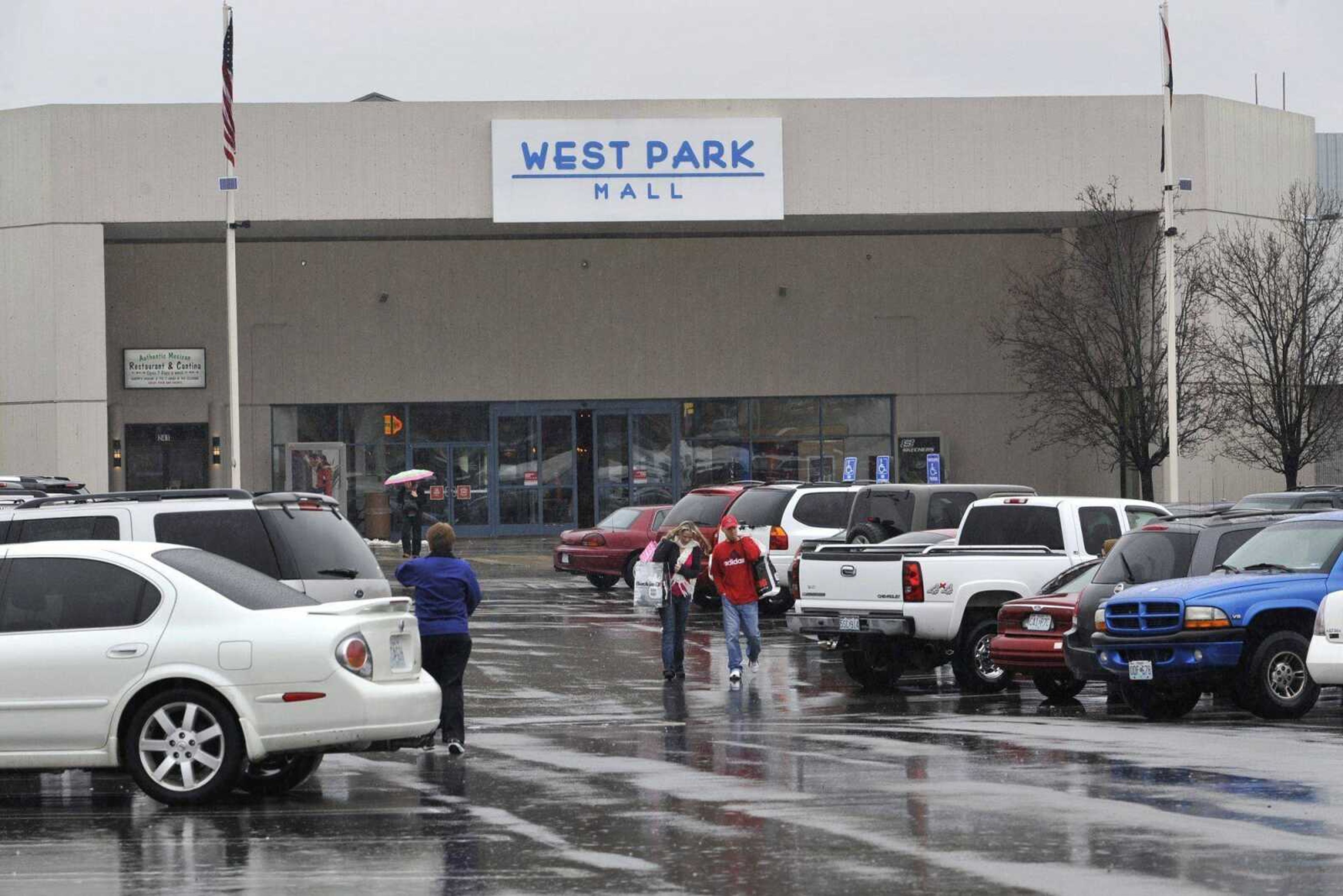 Shoppers walk to and from West Park Mall in Cape Girardeau. Despite some recent departures, mall management and national sales figures indicate that shopping centers are not on the decline. (Fred Lynch)