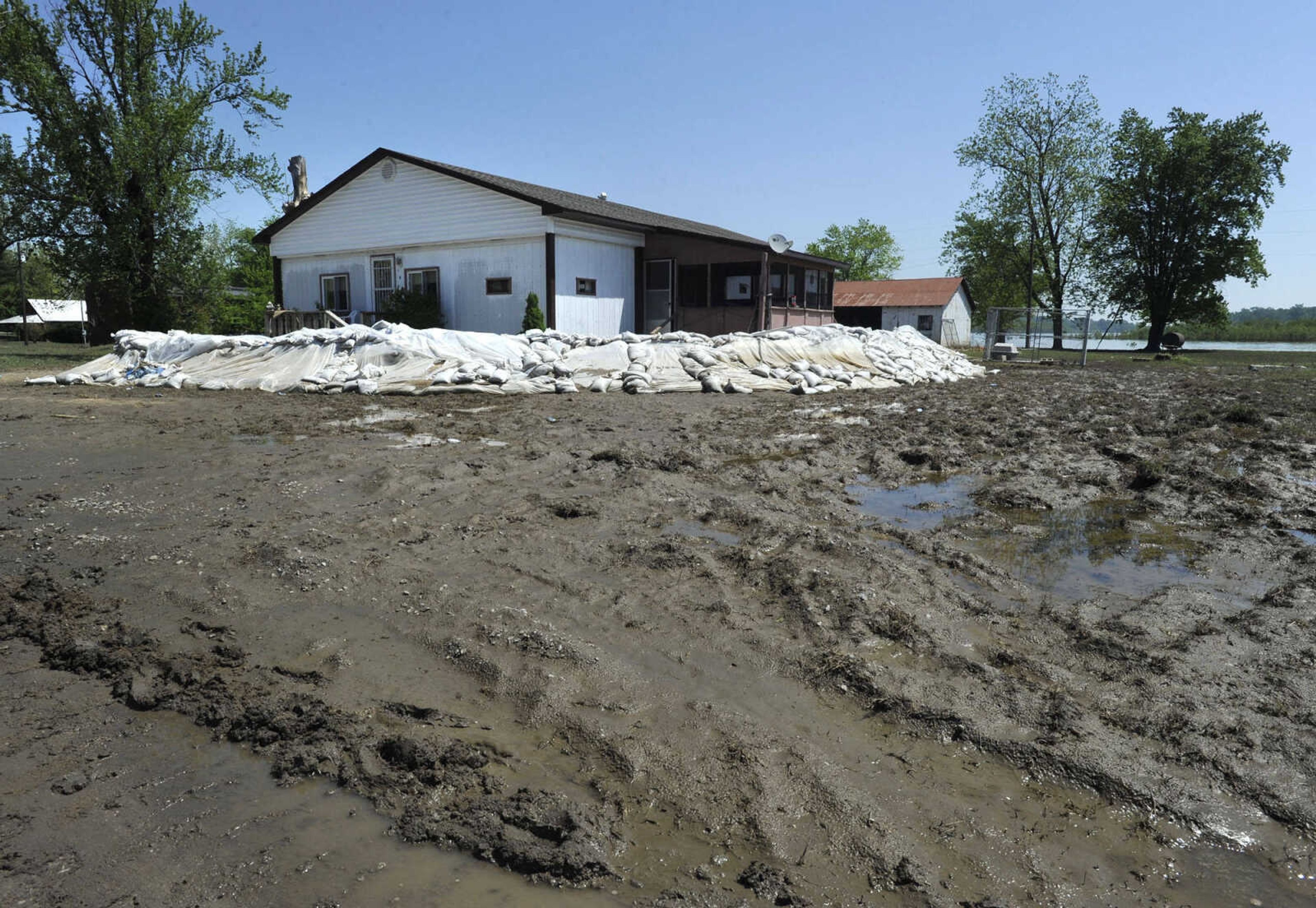 FRED LYNCH ~ flynch@semissourian.com
Receding floodwaters from the Mississippi River leave mud around this sandbagged house Sunday, May 8, 2011 in Commerce, Mo.