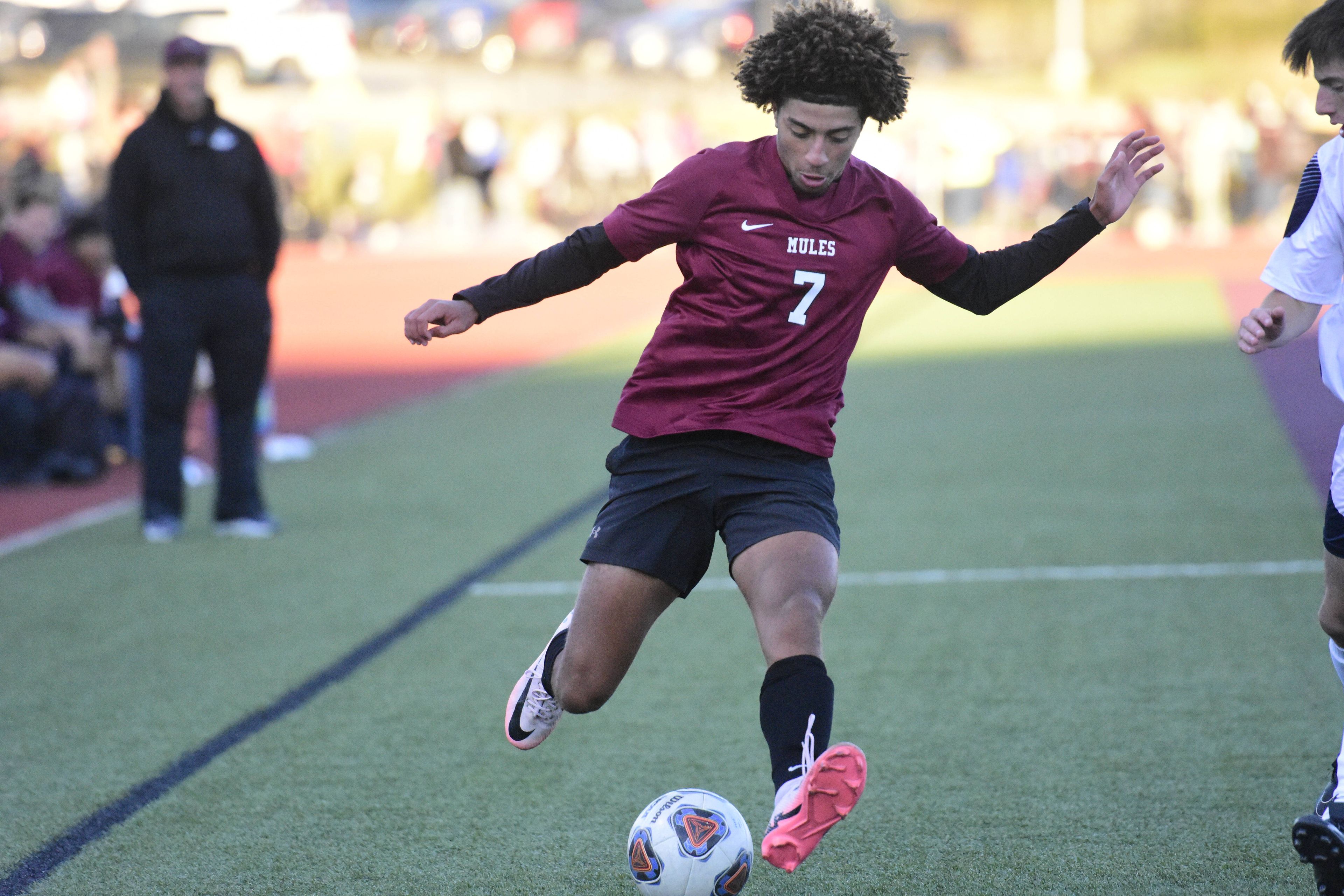 Poplar Bluff junior Lane Dunham takes a kick deep inside Saxony Lutheran’s territory during the first half of Tuesday's soccer game at Mules Stadium.