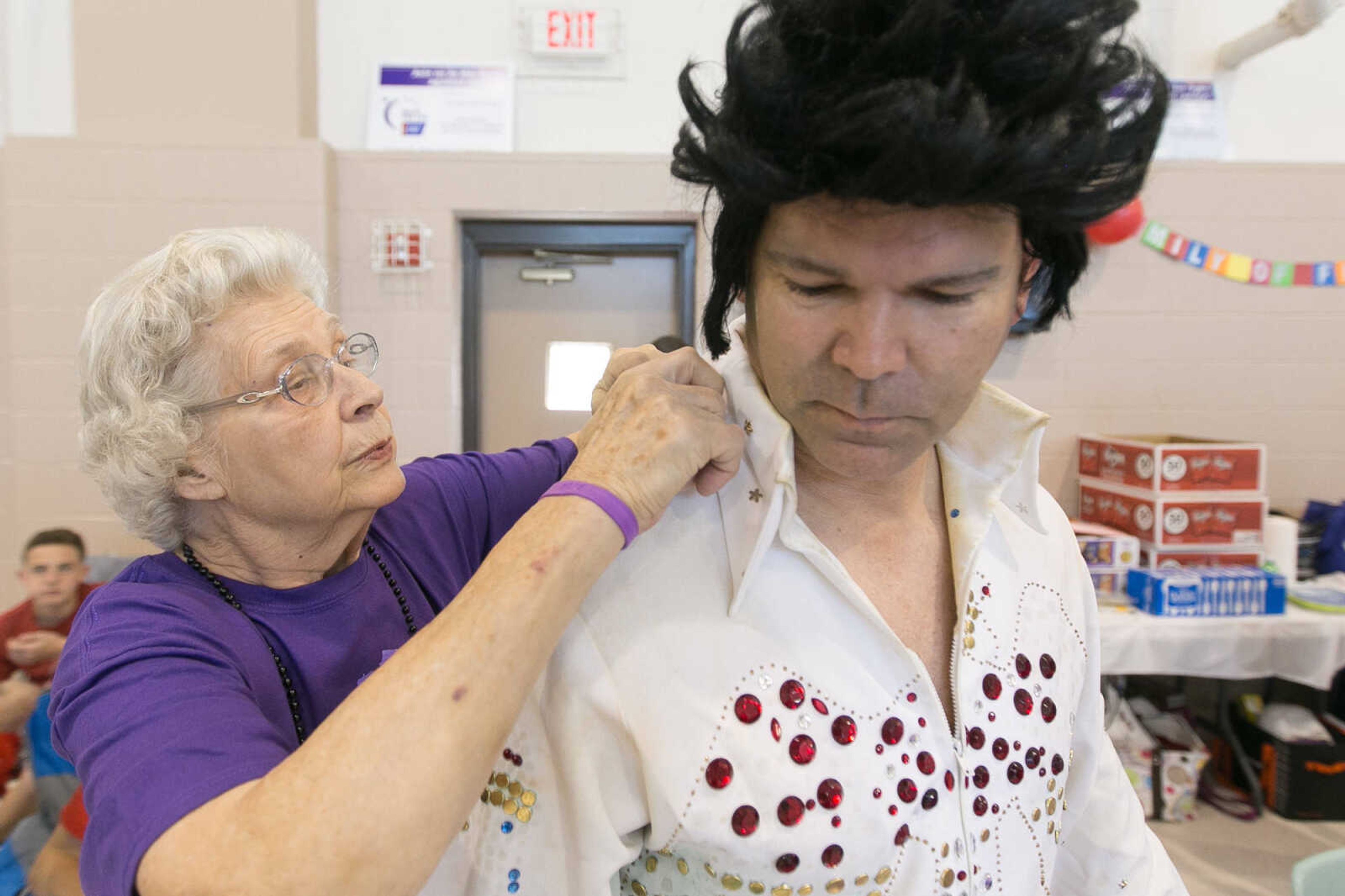 GLENN LANDBERG ~ glandberg@semissourian.com


Frieda Seyer helps Scott Givens, the master of ceremonies for the event , apply a cape to complete his Elvis costume at the Relay for Life of Cape Girardeau County fundraiser in the Osage Centre, Saturday, May 7, 2016.