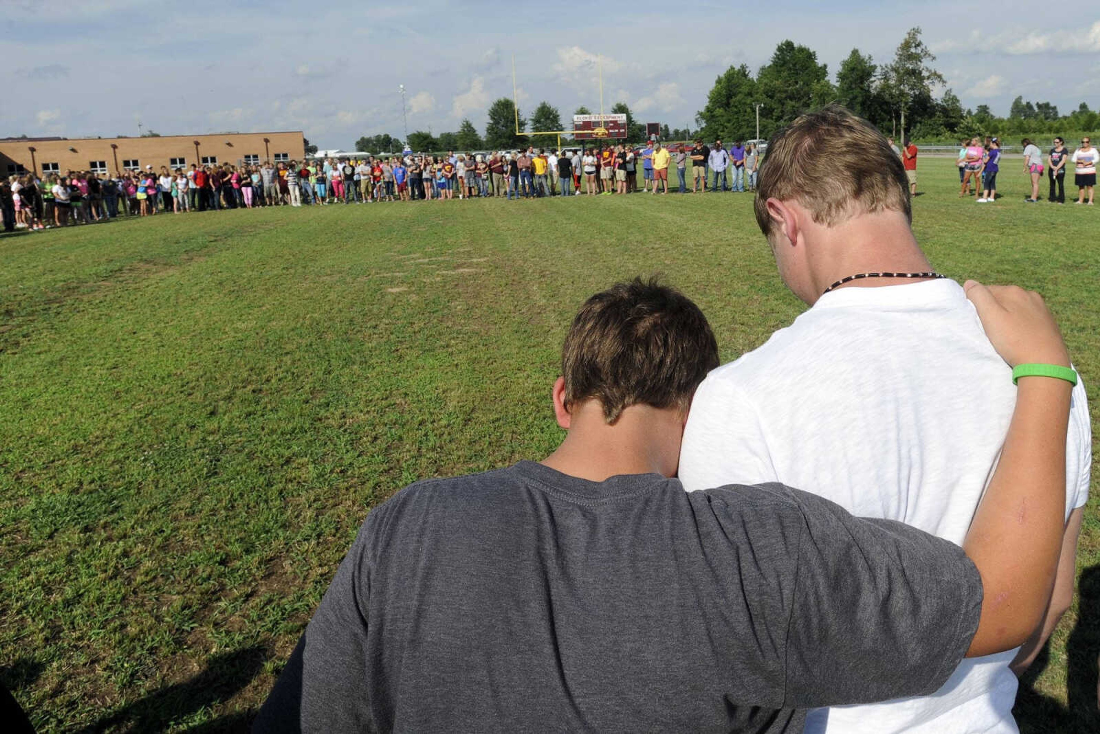 Friends of Kaden Robert gather on the football field Tuesday at Kelly High School near Benton, Missouri. (Fred Lynch)