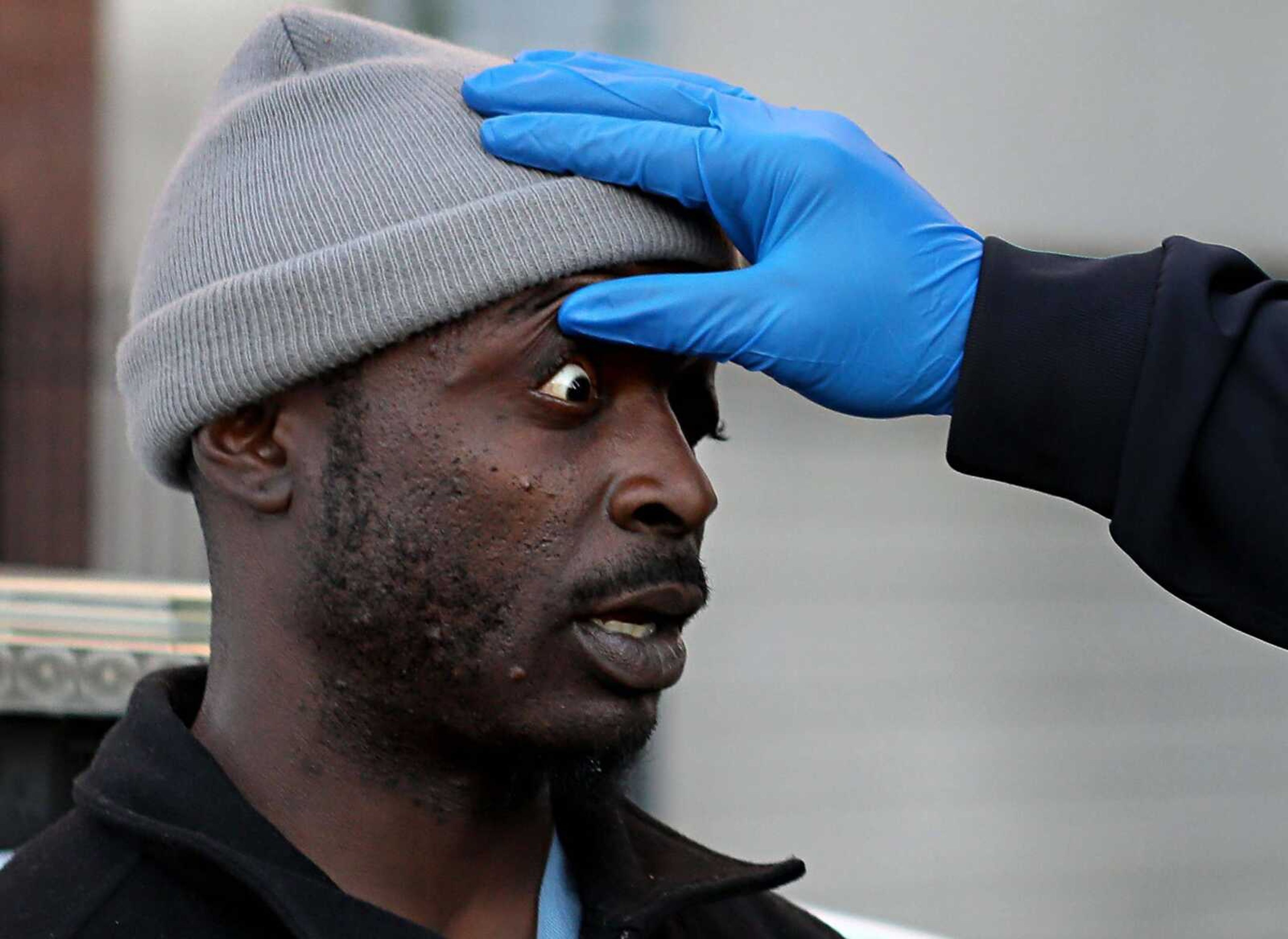 Medics check on the condition of a man found in a catatonic state Nov. 9, likely from synthetic marijuana, in downtown St. Louis.