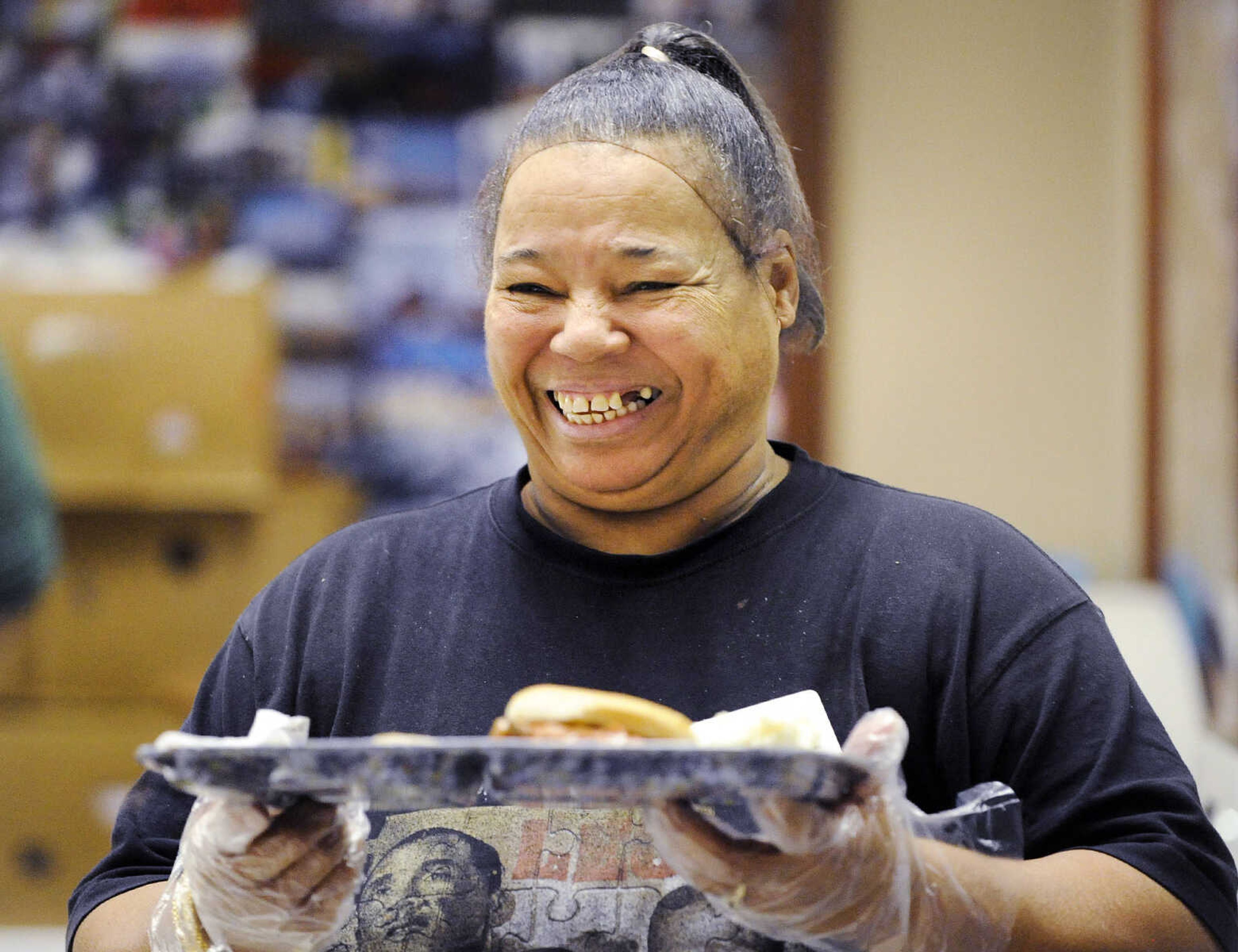 LAURA SIMON ~ lsimon@semissourian.com

Gwyndle McGee hands a hot meal to a patron Monday afternoon, Feb. 22, 2016, during meals with friends at the Salvation Army in Cape Girardeau. The last two full weeks of the month, the Salvation Army hosts meals with friends, an event where people can come have a hot meal, and also take a meal home.