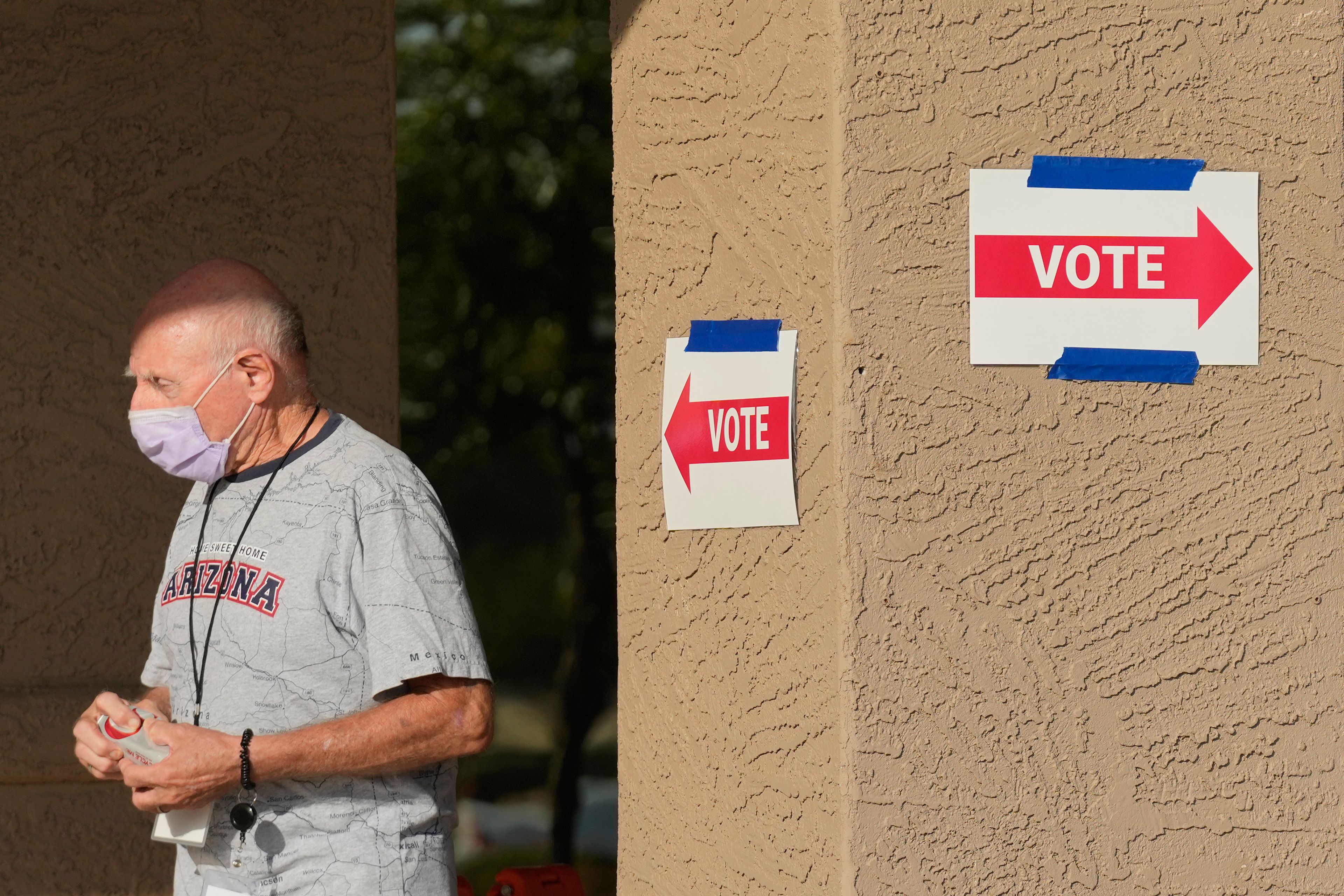 A precinct worker walks outside a voting location during the state's primary election, Tuesday, July 30, 2024, in Sun City West, Ariz. (AP Photo/Ross D. Franklin)