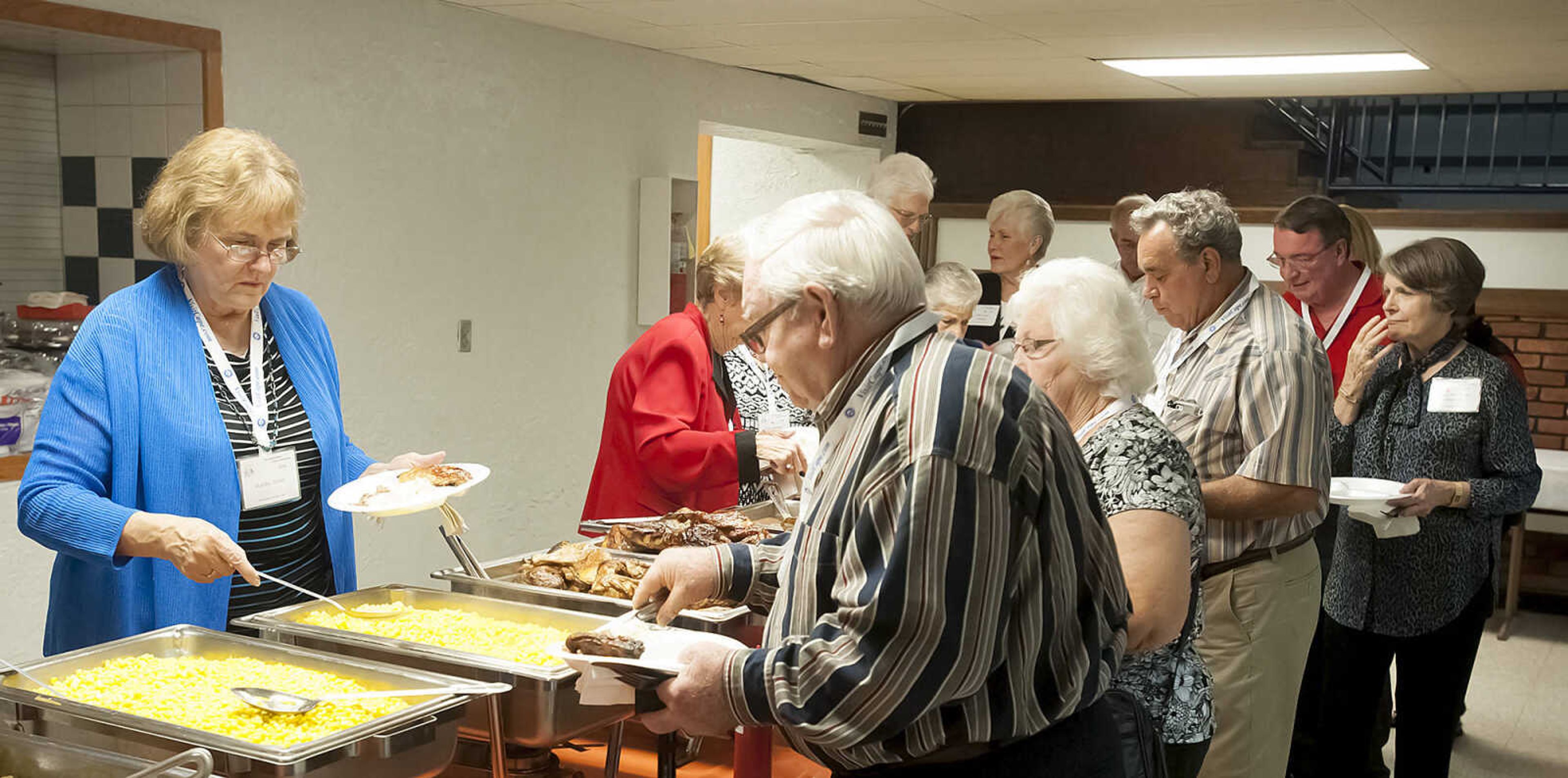 Attendees make their way down the buffet as more than 500 graduates from Central High School gathered for dinner, live music and dancing Saturday, Oct. 5, at the Arena Building in Cape Girardeau. The classes of 1950-1959 gathered for the Fabulous Fifties Central High School Reunion 2013.