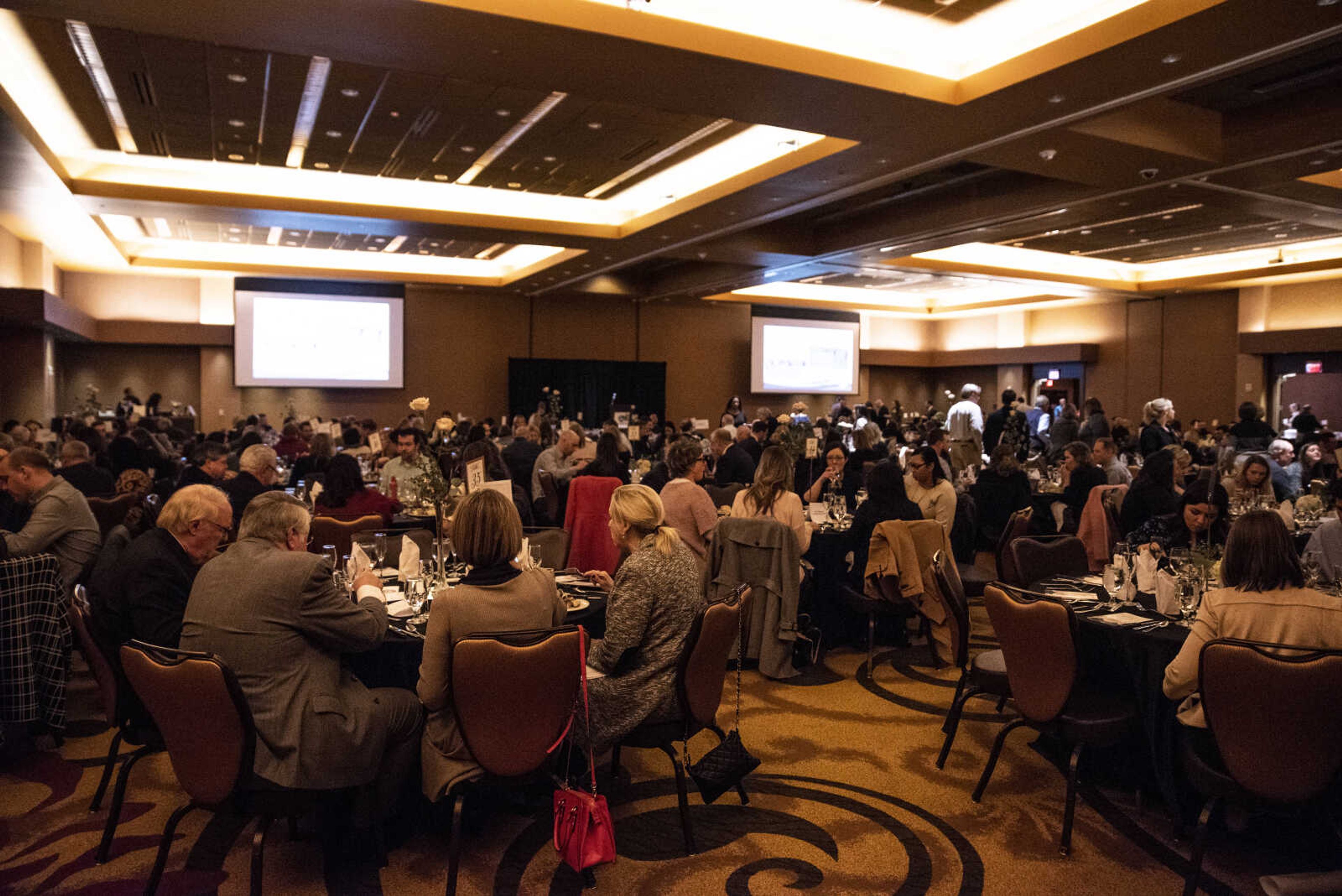 Community members sit at tables and enjoy the Old Town Cape 20th anniversary dinner celebration at the Isle Casino Thursday, Feb. 28, 2019, in Cape Girardeau.