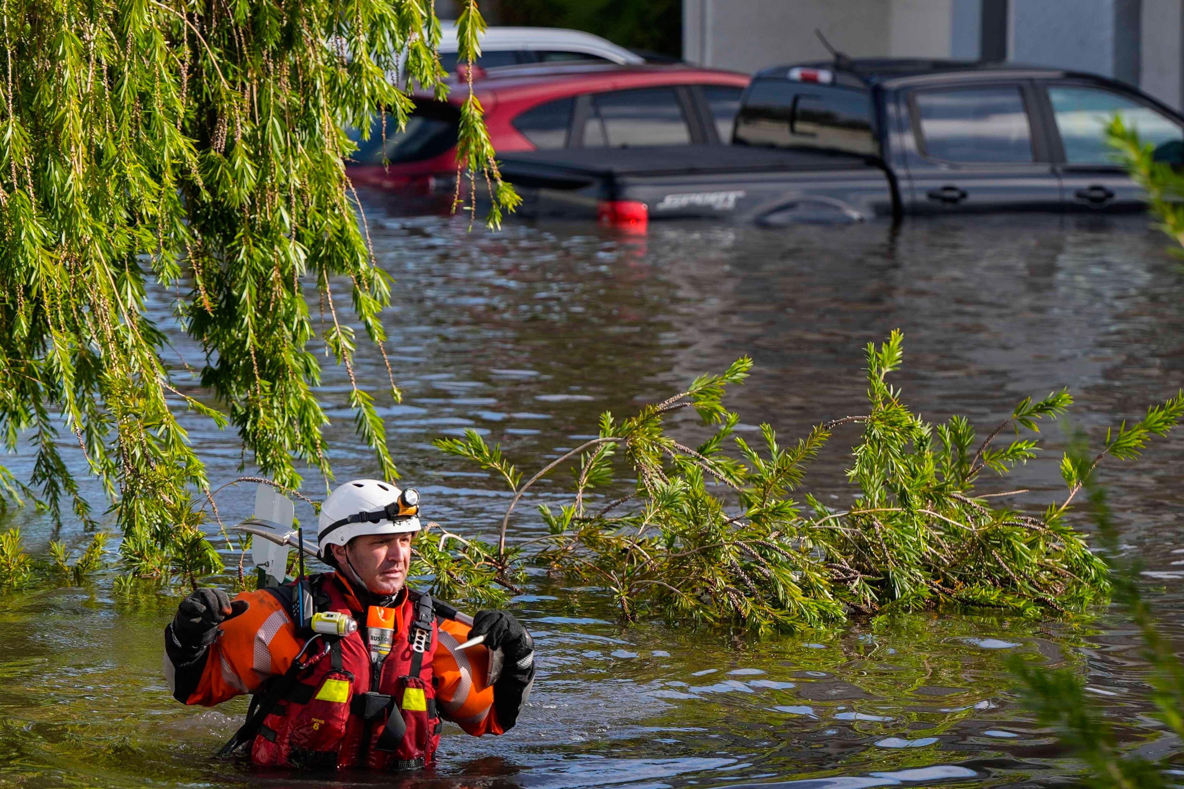 A water rescue team member walks through flood waters at an apartment complex in the aftermath of Hurricane Milton, Thursday, Oct. 10, 2024, in Clearwater, Fla. (AP Photo/Mike Stewart)