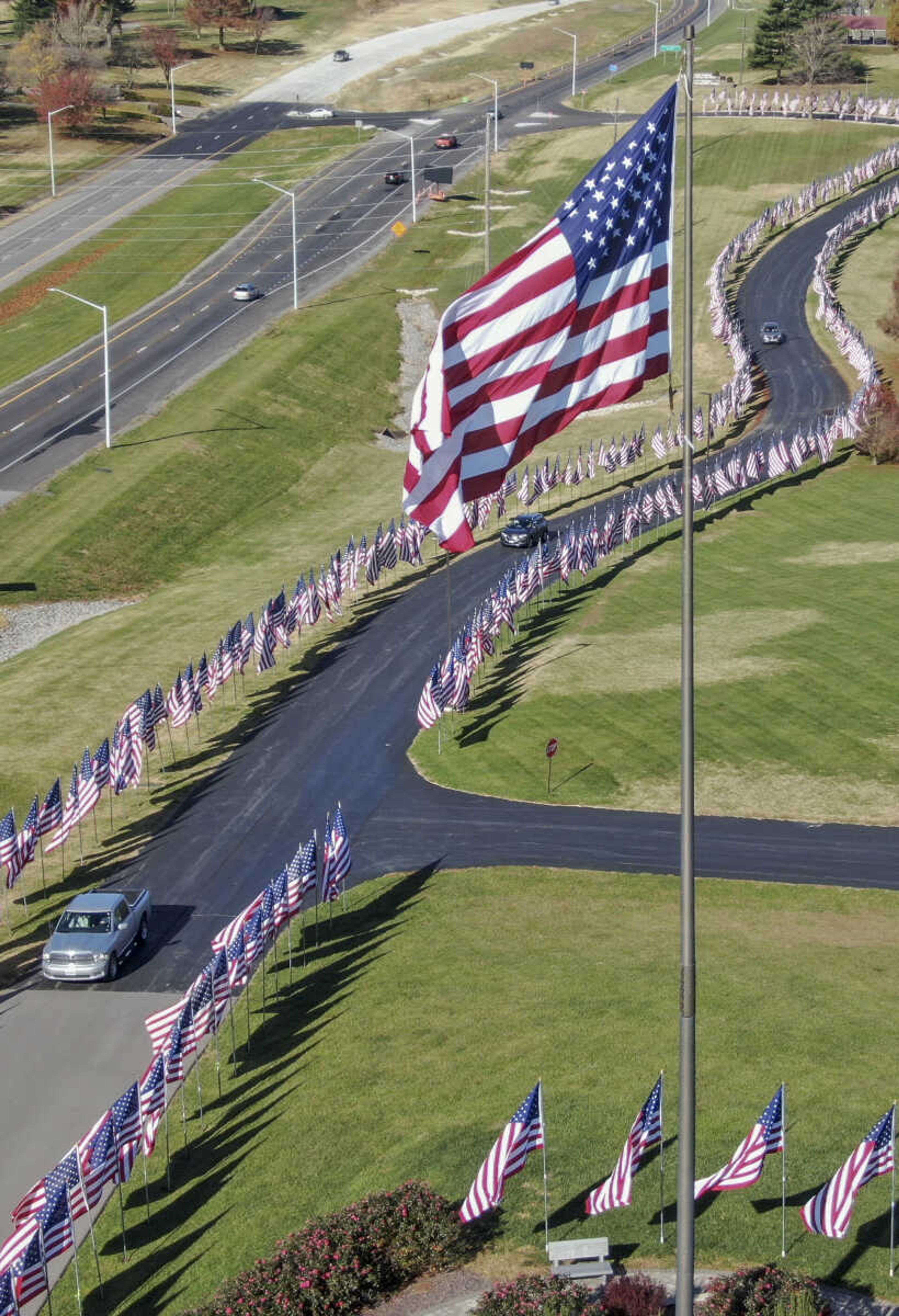 Cars drive down the Avenue of Flags at Cape County Park North in Cape Girardeau on Wednesday, Nov. 11, 2020.