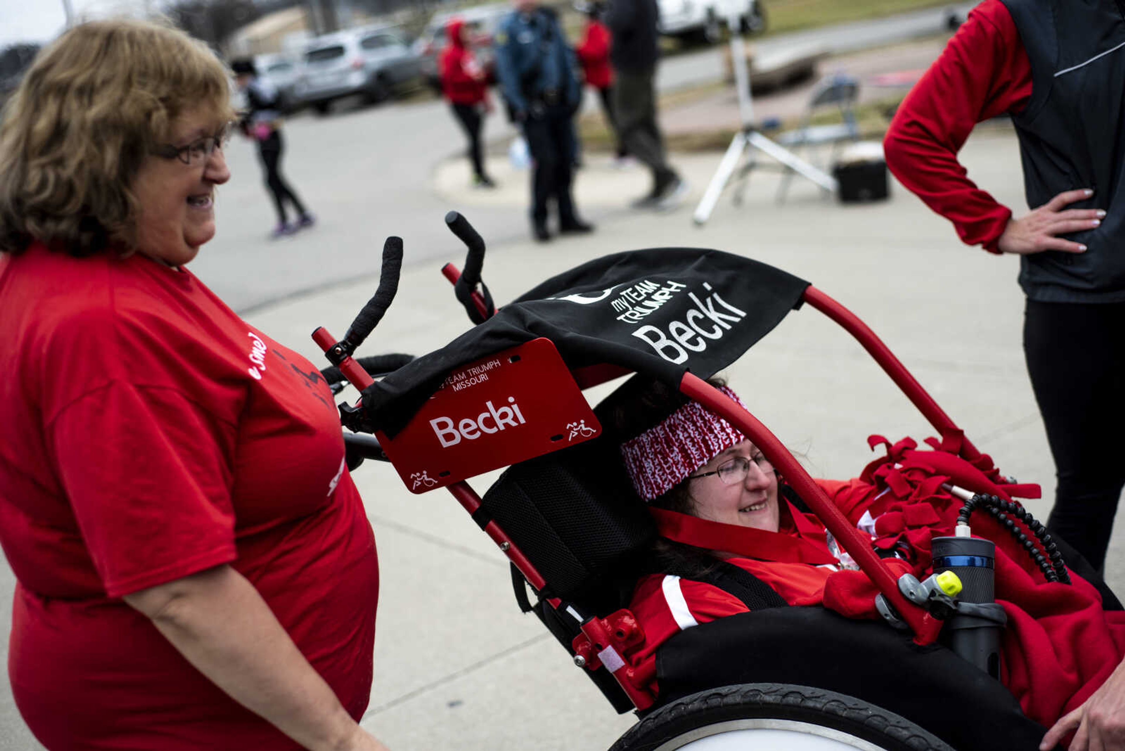 Becki Nation, center, talks with My Team Triumph volunteers while her mother Margie Nation, left, stands next to her after the Resolution Challenge Tuesday, Jan. 1, 2019, at Arena Park in Cape Girardeau.