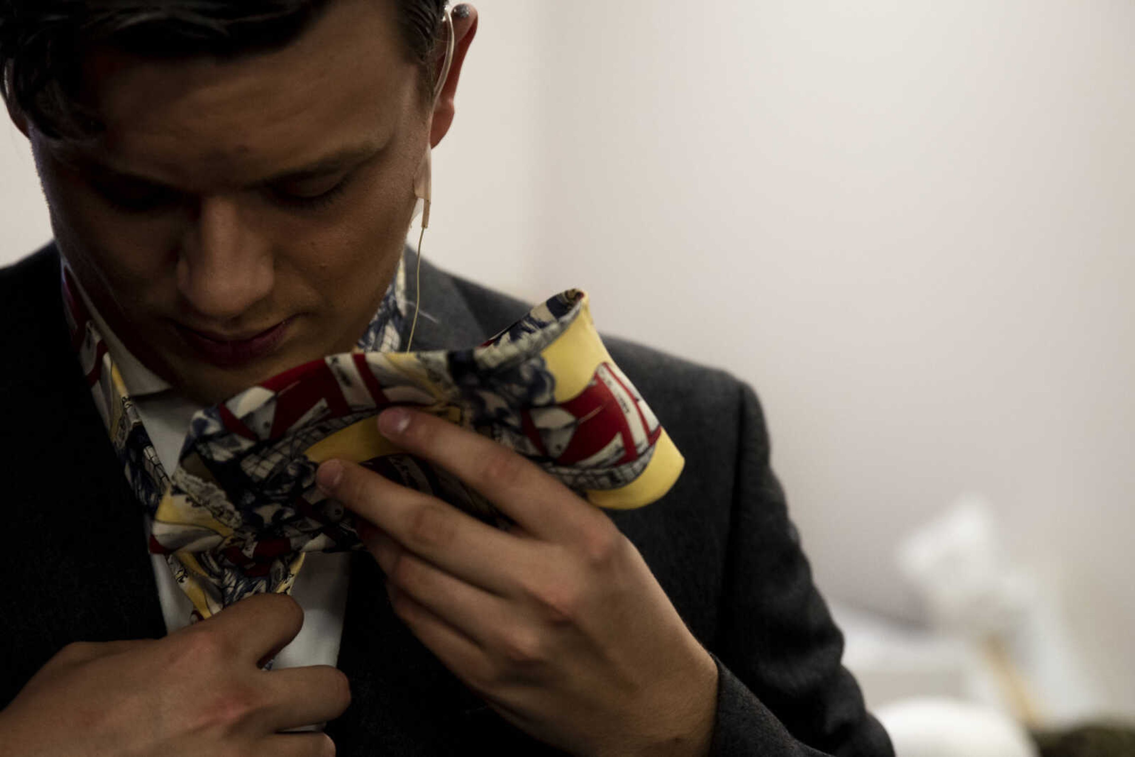 Tyler Helm, 17, ties a tie to complete his character, Harry Bright's, look during the media night of Cape Central High School's spring musical production of "Mamma Mia!" Wednesday, April 10, 2019, in Cape Girardeau.