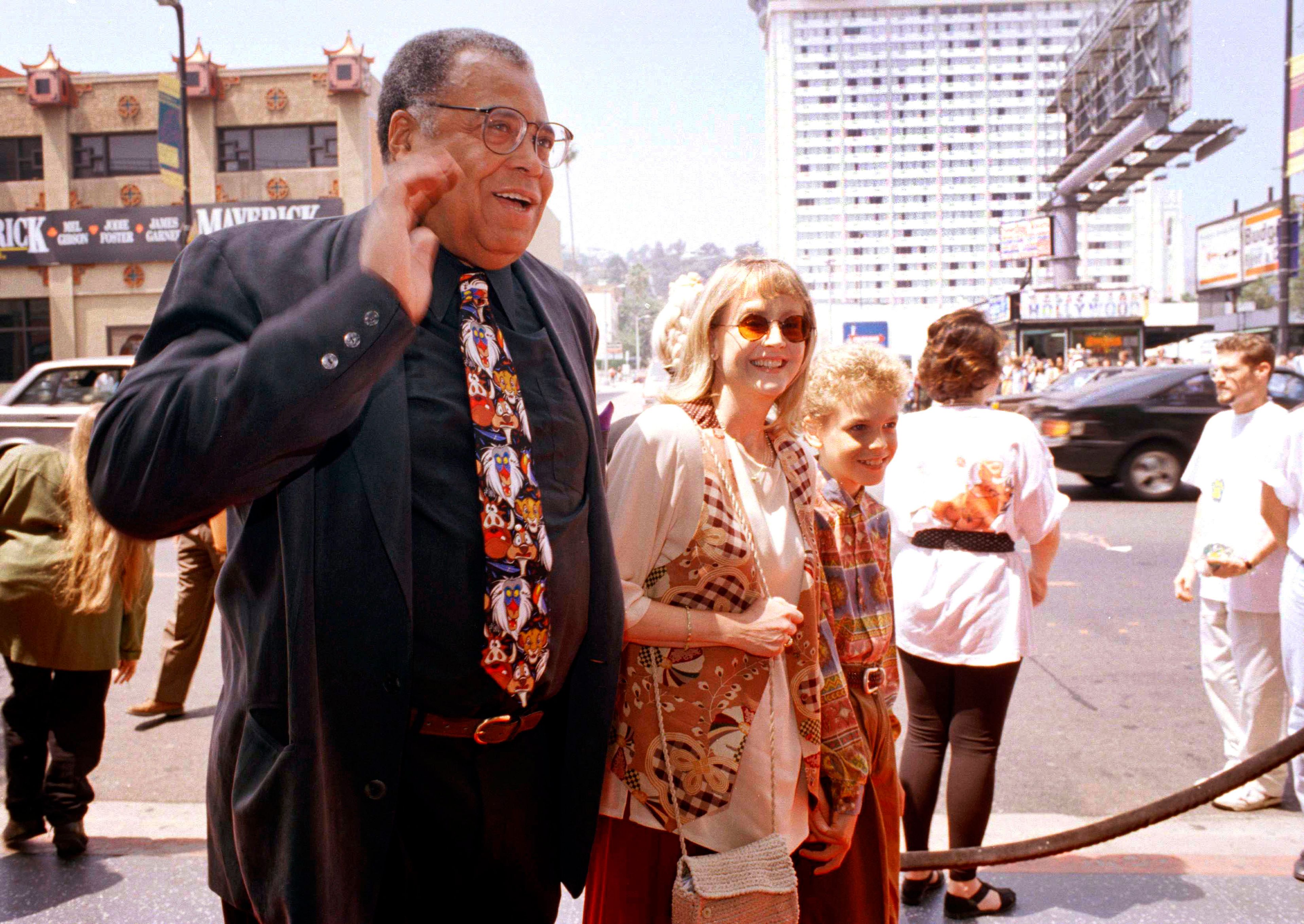 FILE - James Earl Jones, left, greets the press along with his wife Cecilia, center, and son Flynn, right, at the premiere of "The Lion King" in Los Angeles, June 12, 1994. Jones, who overcame racial prejudice and a severe stutter to become a celebrated icon of stage and screen has died at age 93, Monday, Sept. 9, 2024. (AP Photo/Tara Farrell, File)