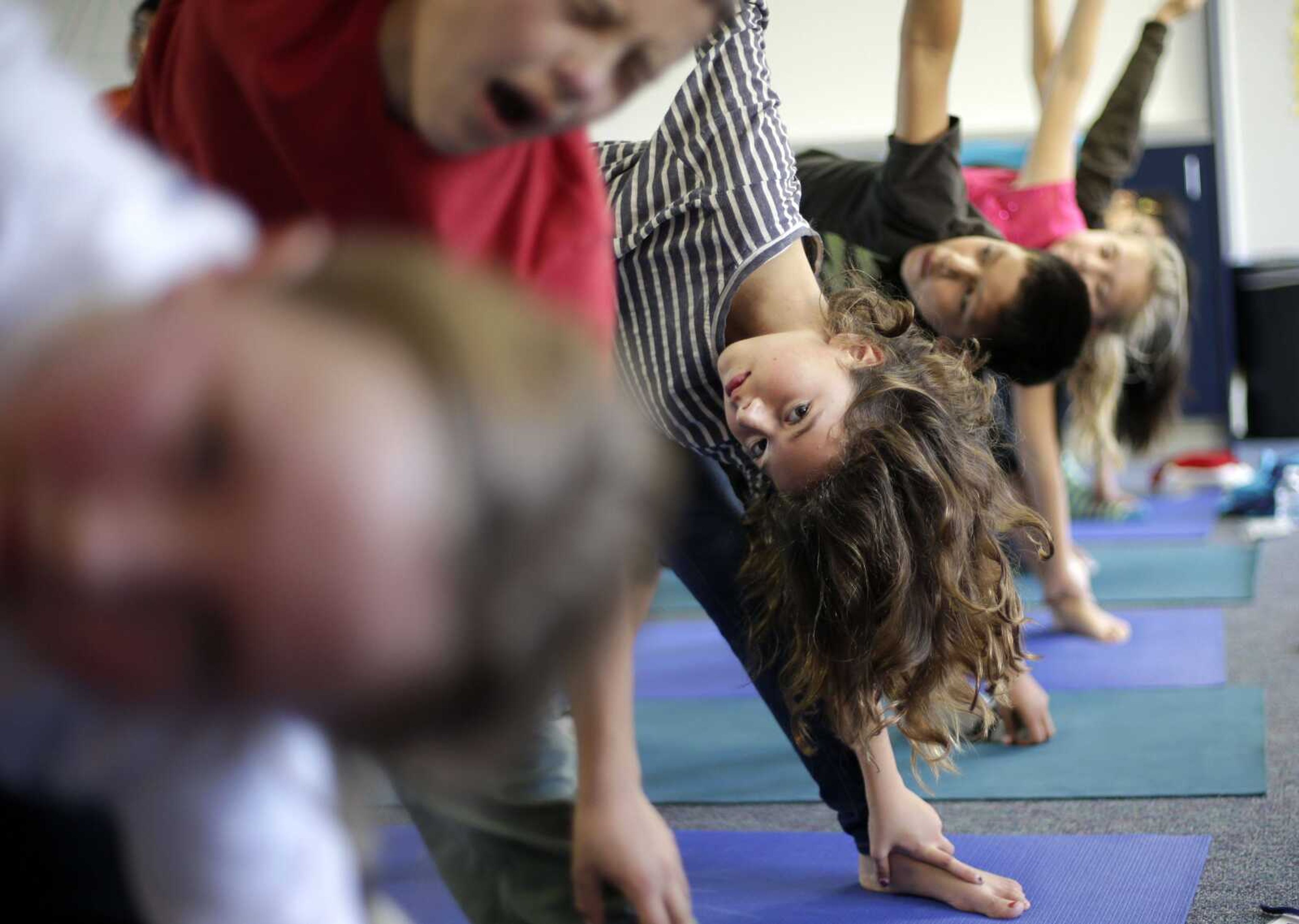 Students hold a yoga pose during a physical education class at Capri Elementary School in Encinitas, Calif. (Gregory Bull ~ Associated Press)