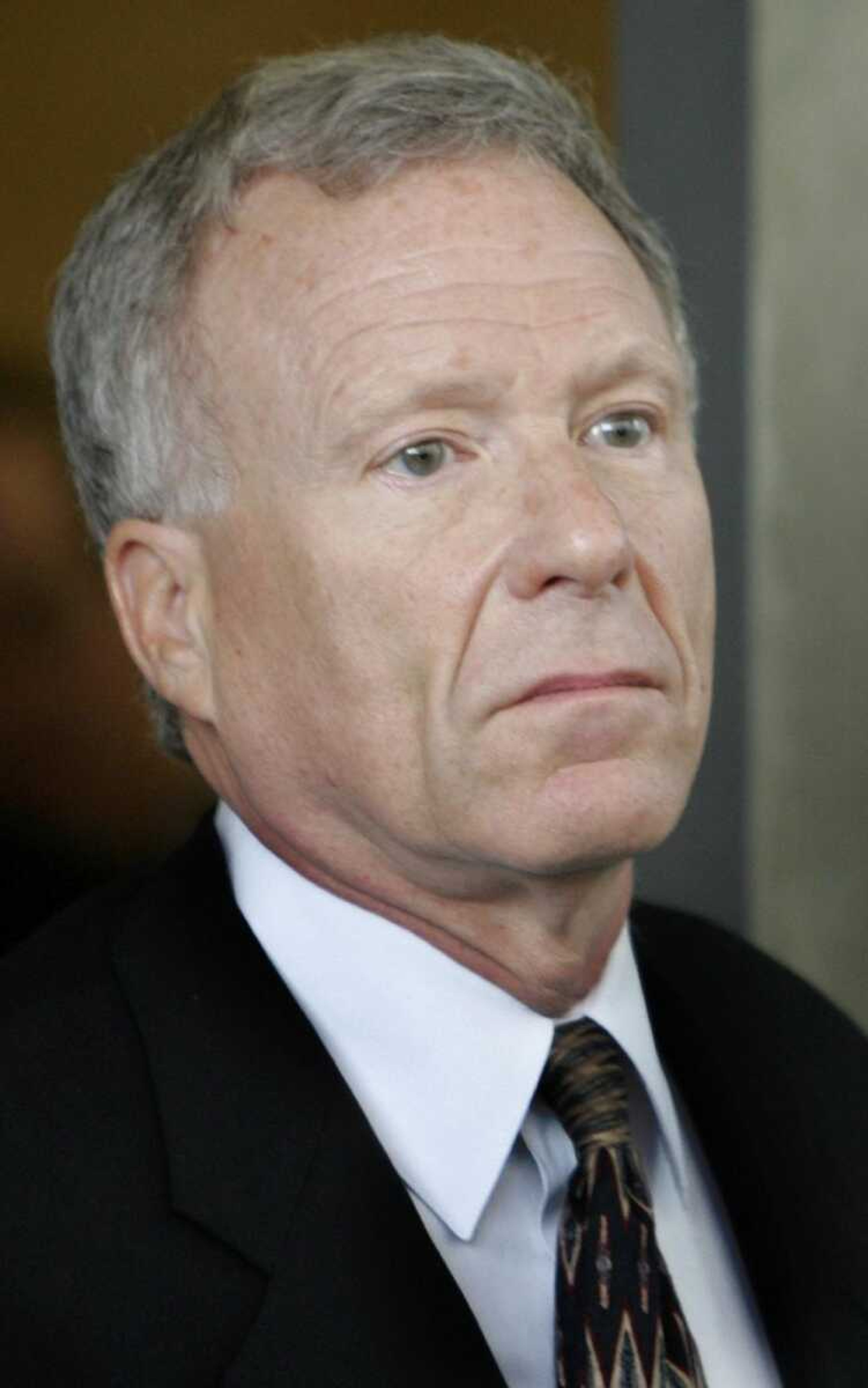 Former White House aide I. Lewis "Scooter" Libby walks towards his car outside federal court in Washington, Tuesday, June 5, 2007, after he was sentenced to 2 1/2 years in prison for lying and obstructing the CIA leak investigation. (AP Photo/Charles Dharapak)