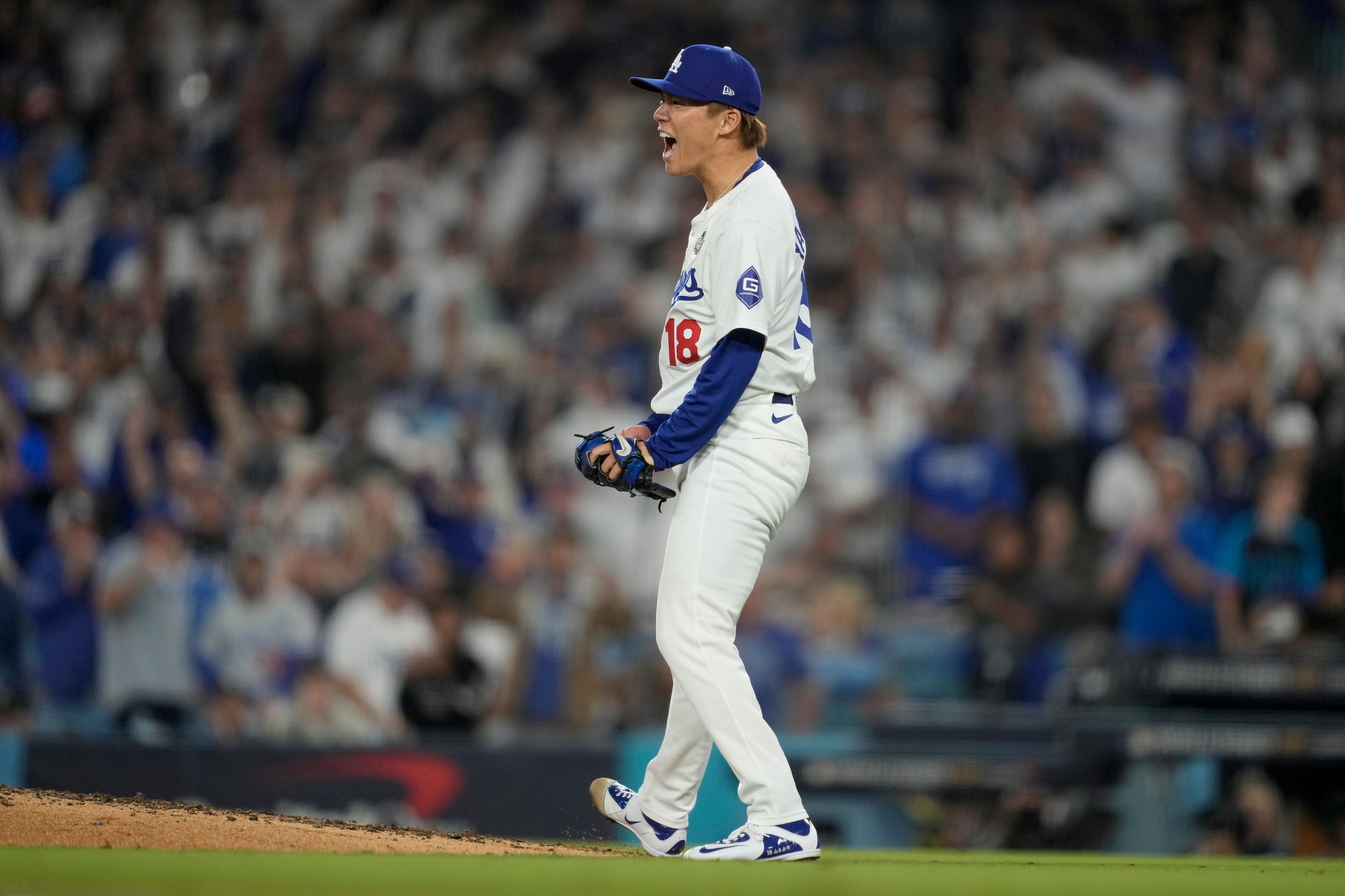 Los Angeles Dodgers pitcher Yoshinobu Yamamoto celebrates the end of the top of the sixth inning in Game 2 of the baseball World Series against the New York Yankees, Saturday, Oct. 26, 2024, in Los Angeles. (AP Photo/Ashley Landis)