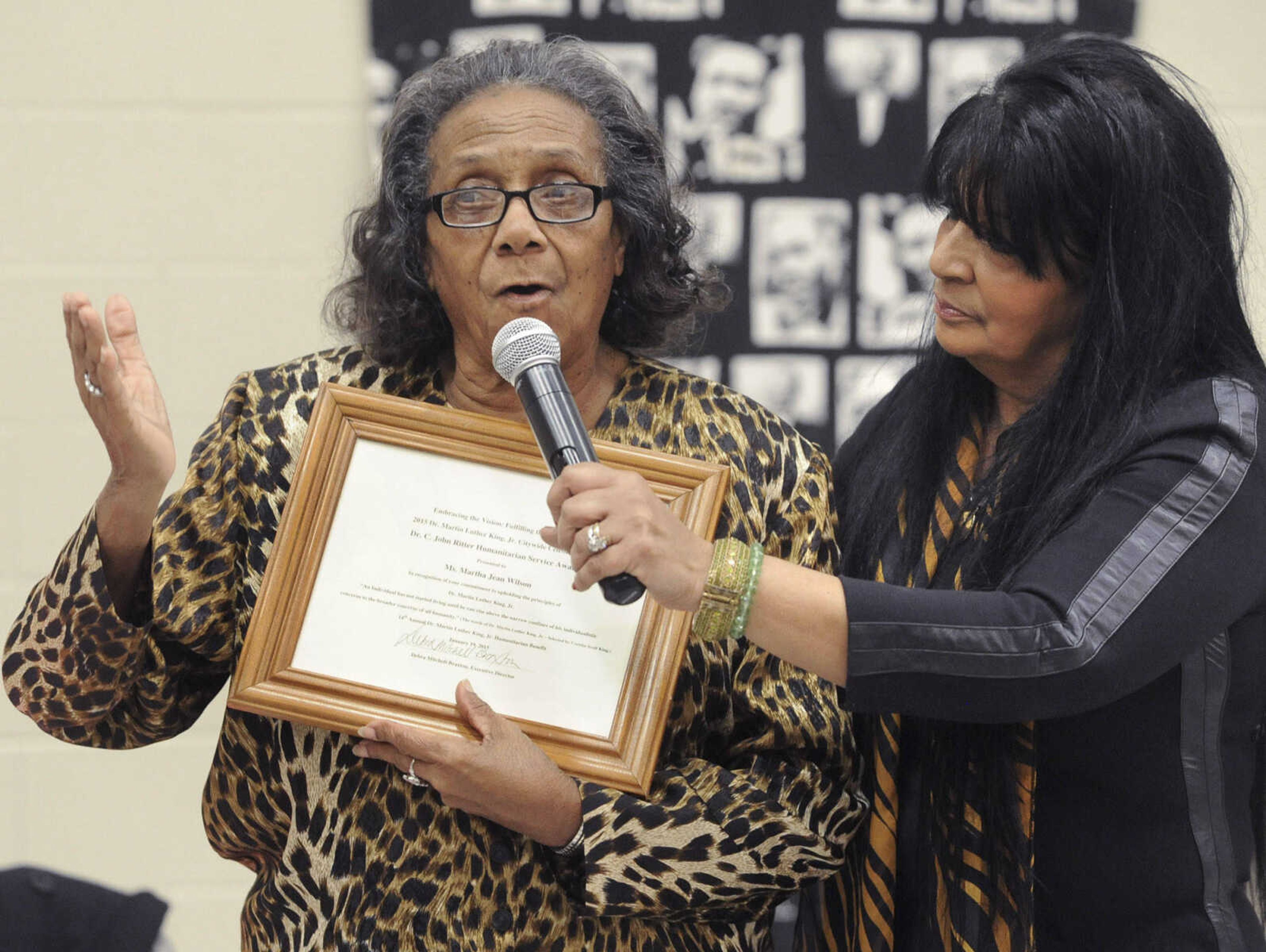 FRED LYNCH ~ flynch@semissourian.com
Martha Jean Wilson, left, reacts to receiving a Dr. C. John Ritter Humanitarian Award from Debra Mitchell-Braxton at the Dr. Martin Luther King Jr. Humanitarian Luncheon Monday, Jan. 19, 2015 at the Salvation Army in Cape Girardeau.