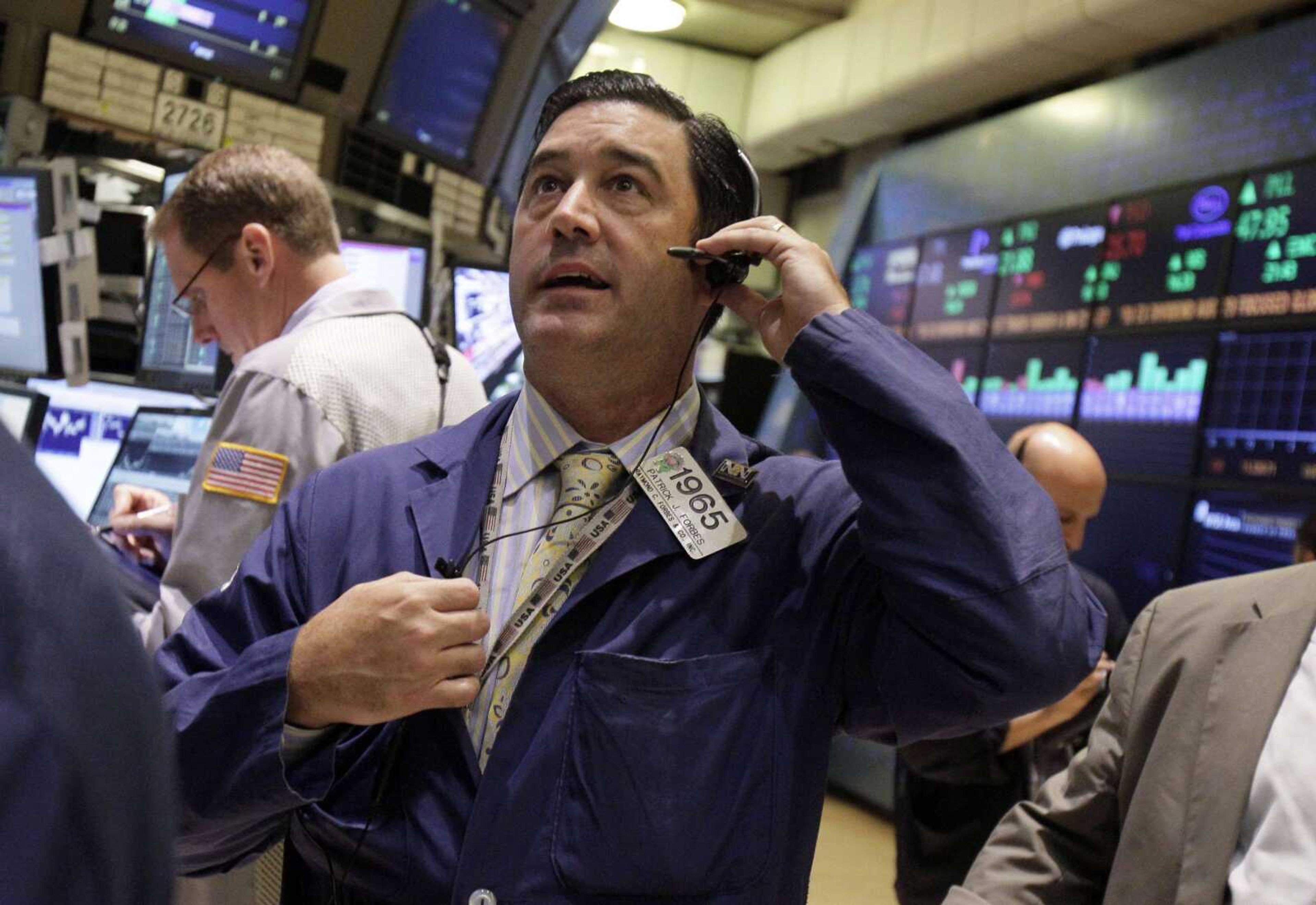 Trader Patrick Forbes works Thursday on the floor of the New York Stock Exchange. (Richard Drew ~ Associated Press)