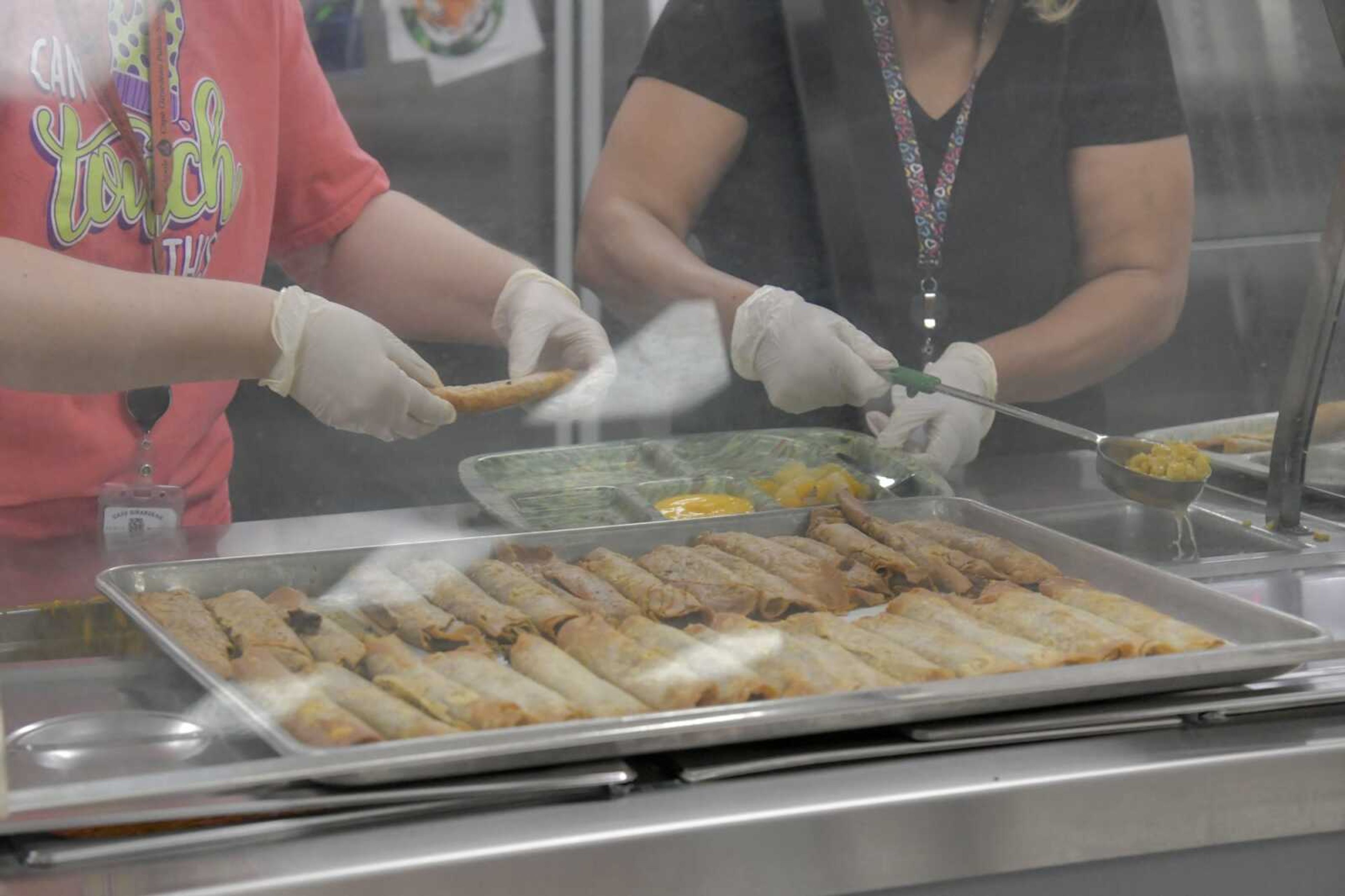 Cafeteria staff prepare lunch plates with crispitos at Alma Schrader Elementary School on Thursday in Cape Girardeau.