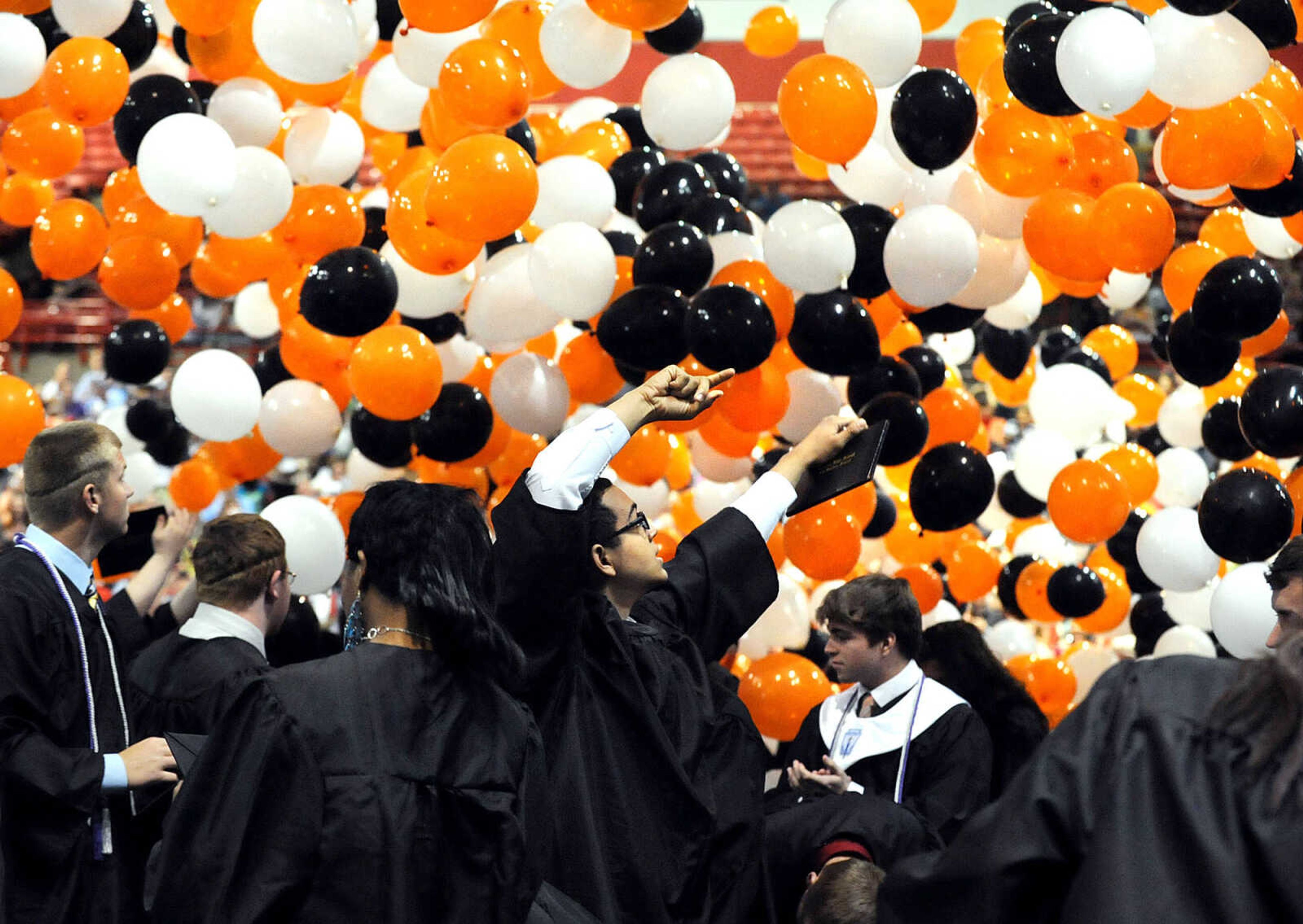 LAURA SIMON ~ lsimon@semissourian.com

Orange, white and black balloons drop from the ceiling, surrounding graduates of Cape Central High School, Sunday, May 12, 2013, at the conclusion of the Tigers' one-hundred first commencement at the Show Me Center.