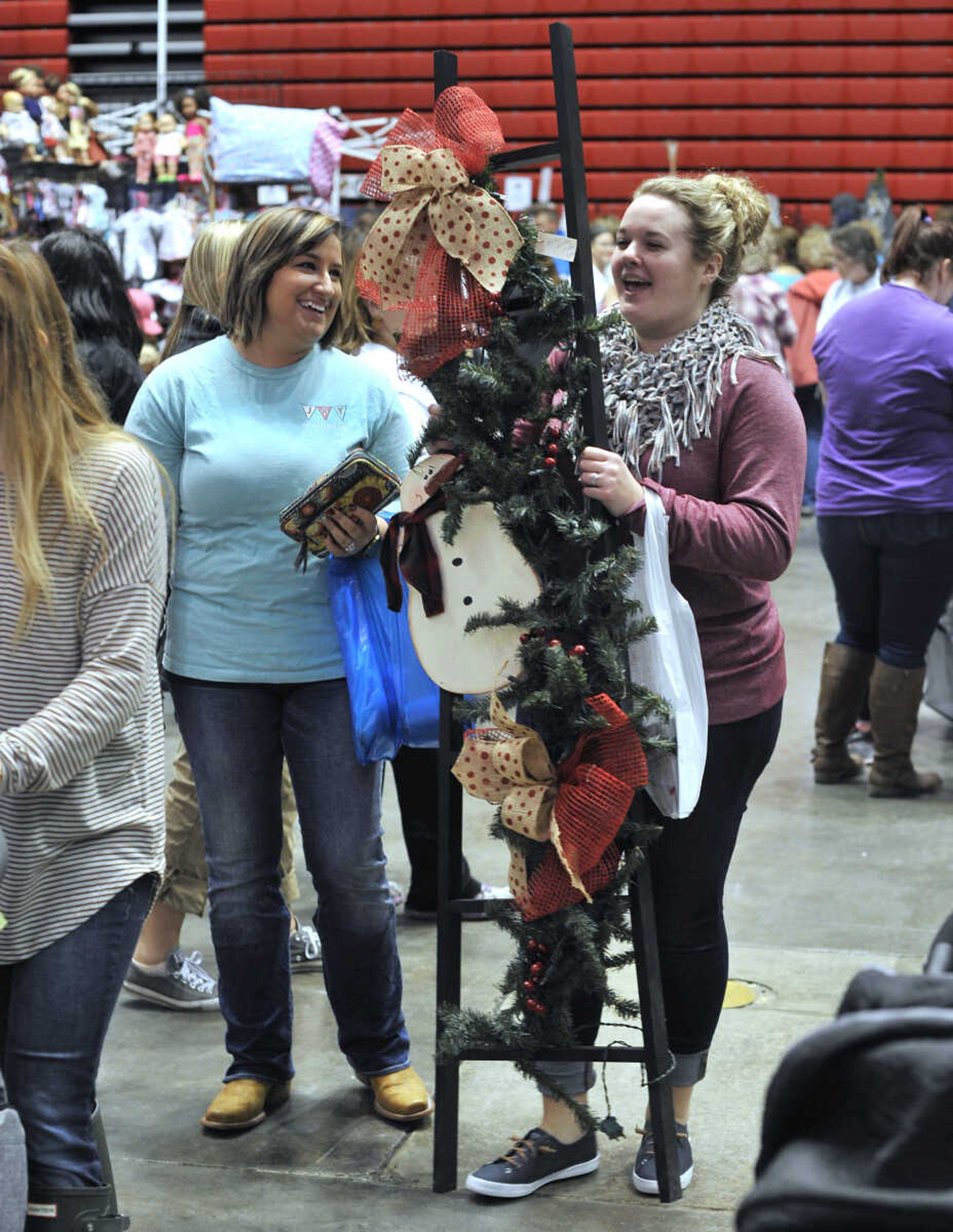 FRED LYNCH ~ flynch@semissourian.com
Alicia Jordan, left, of Tamms, Illinois walks with Morgan Brugger who bought a snowman ladder Saturday, Nov. 18, 2017 at the Christmas Arts & Crafts Extravaganza in the Show Me Center.