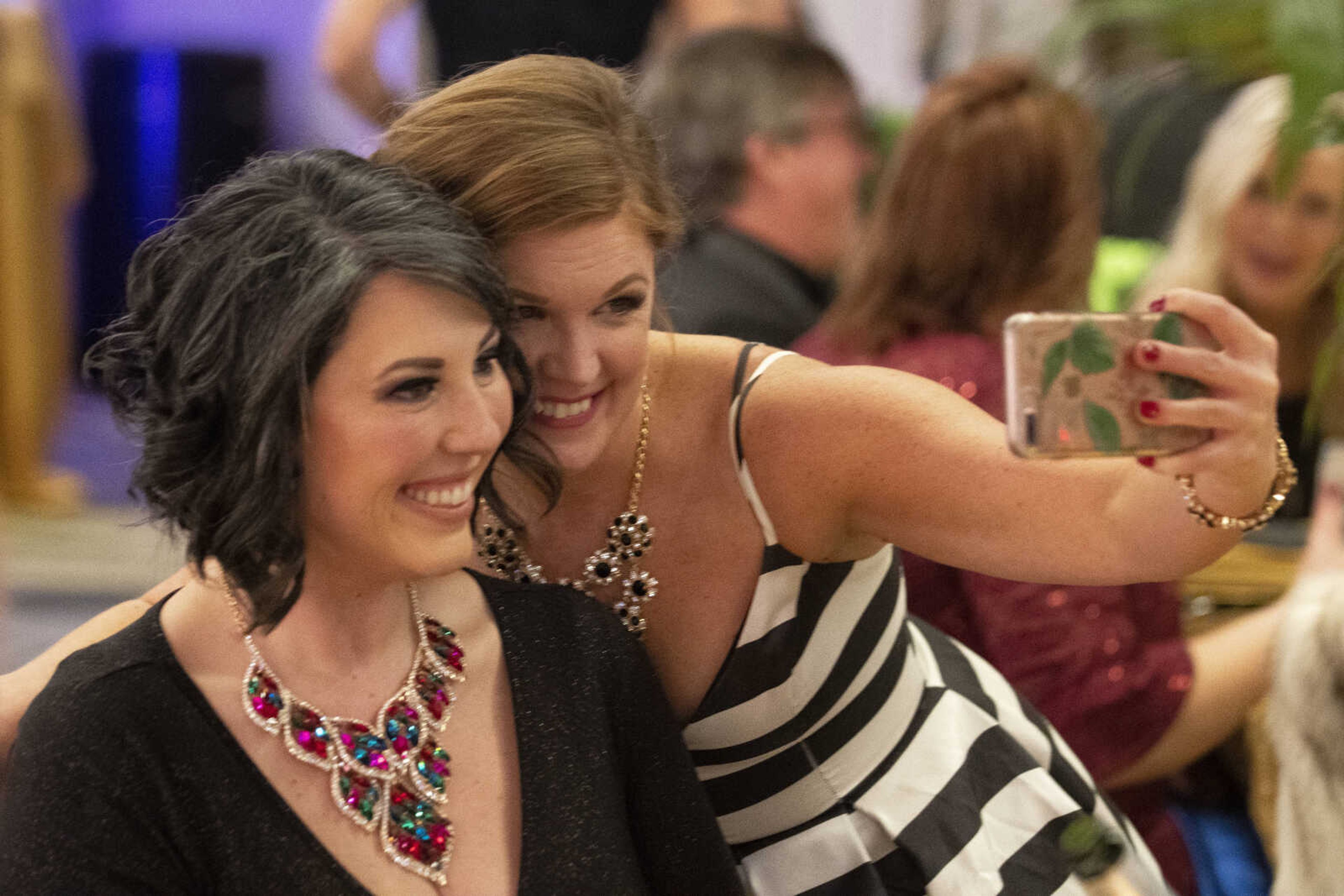 Jennifer Deschenes, with phone, takes a selfie with Jill Sanders, both of Cape Girardeau, during the 2019 Journey Gala at the Drury Plaza Hotel Conference Center on Saturday, Jan. 19, 2019, in Cape Girardeau. The gala benefits cancer patients at Southeast Cancer Center.