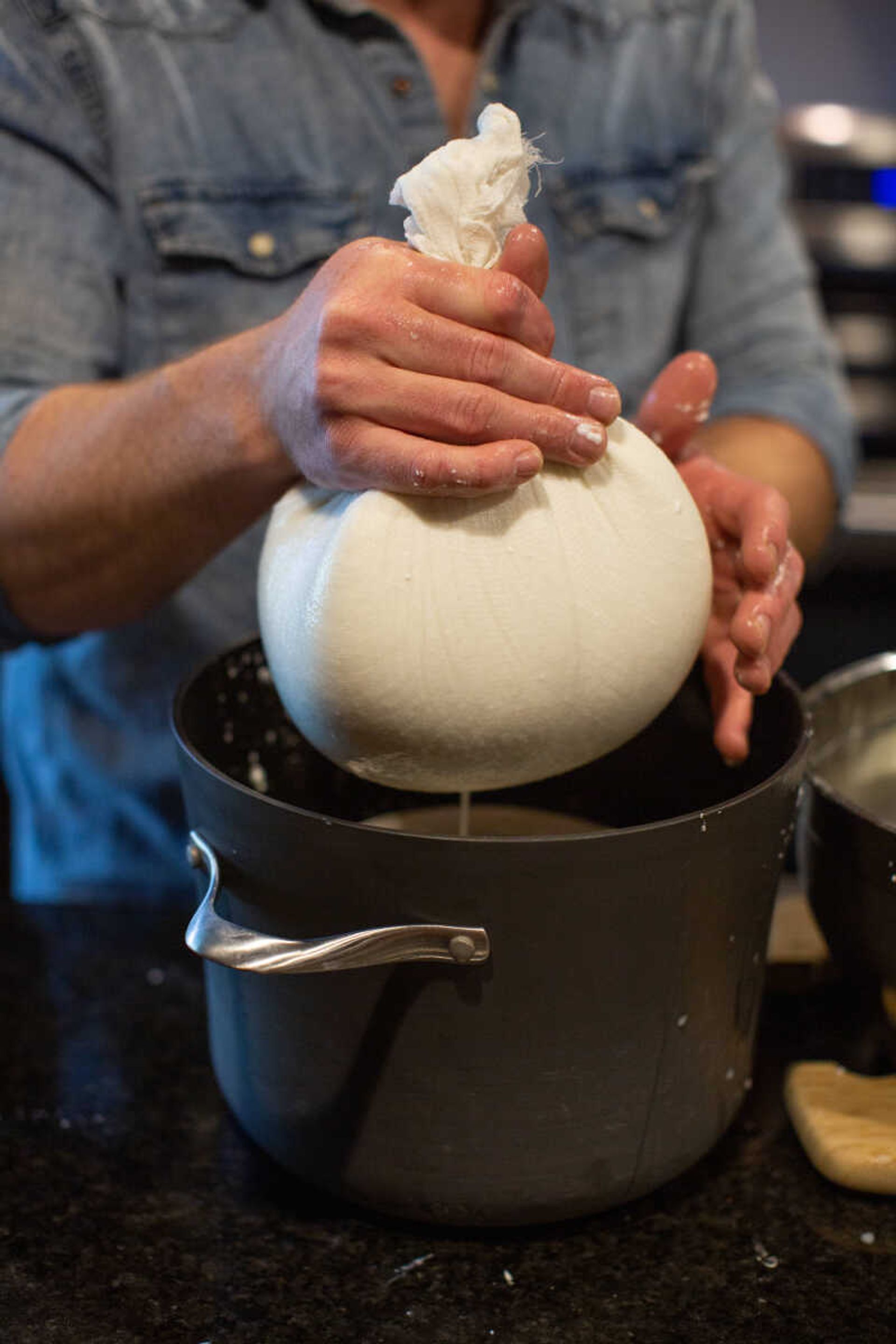 Whey drains from a cheesecloth filled with curd. Steffie Duncan says if they start the cheesemaking process in the morning, they can have cheese by suppertime.