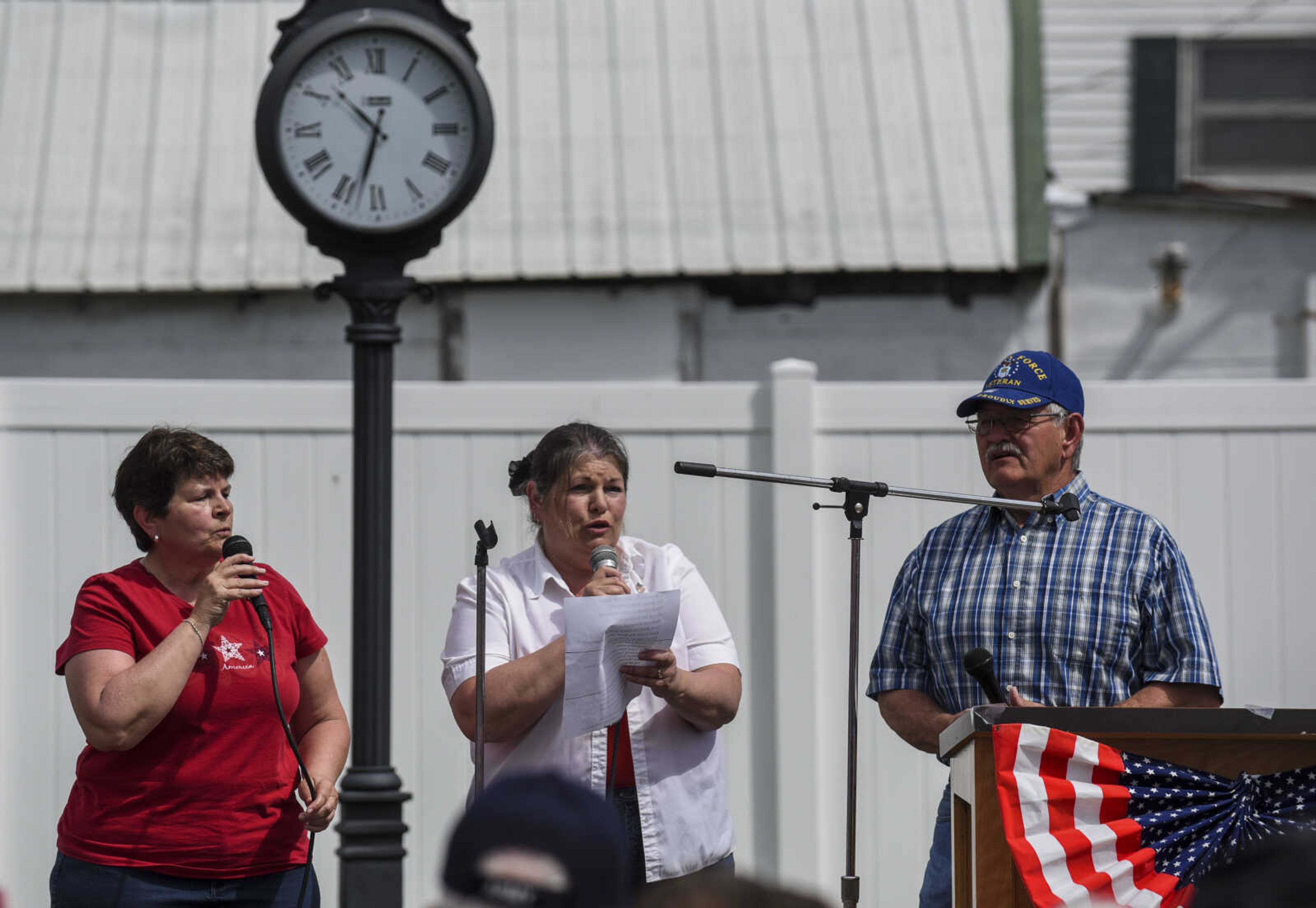 From left, Scott City graduates and community members Patty Rhymer, Penny Rhymer Davidson and Roger Rhymer sing patriotic songs at the Honoring our Military event Saturday, May 5, 2018, at the Scott City Historical Museum in Scott City.