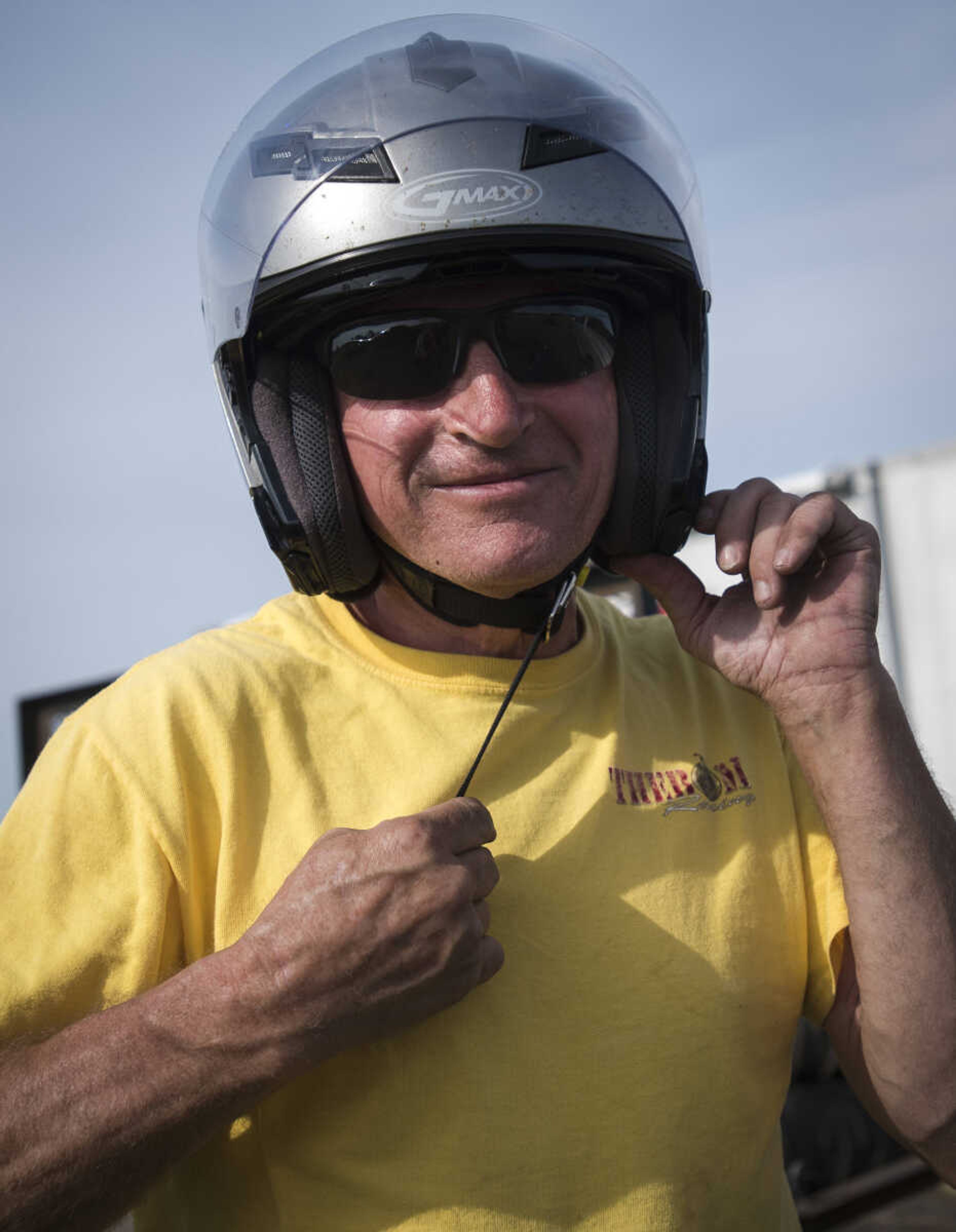 Faron Fowler straps up his helmet before a trial run at the Missouri Dirt Motorsports Saturday, August 12, 2017 in Sikeston.