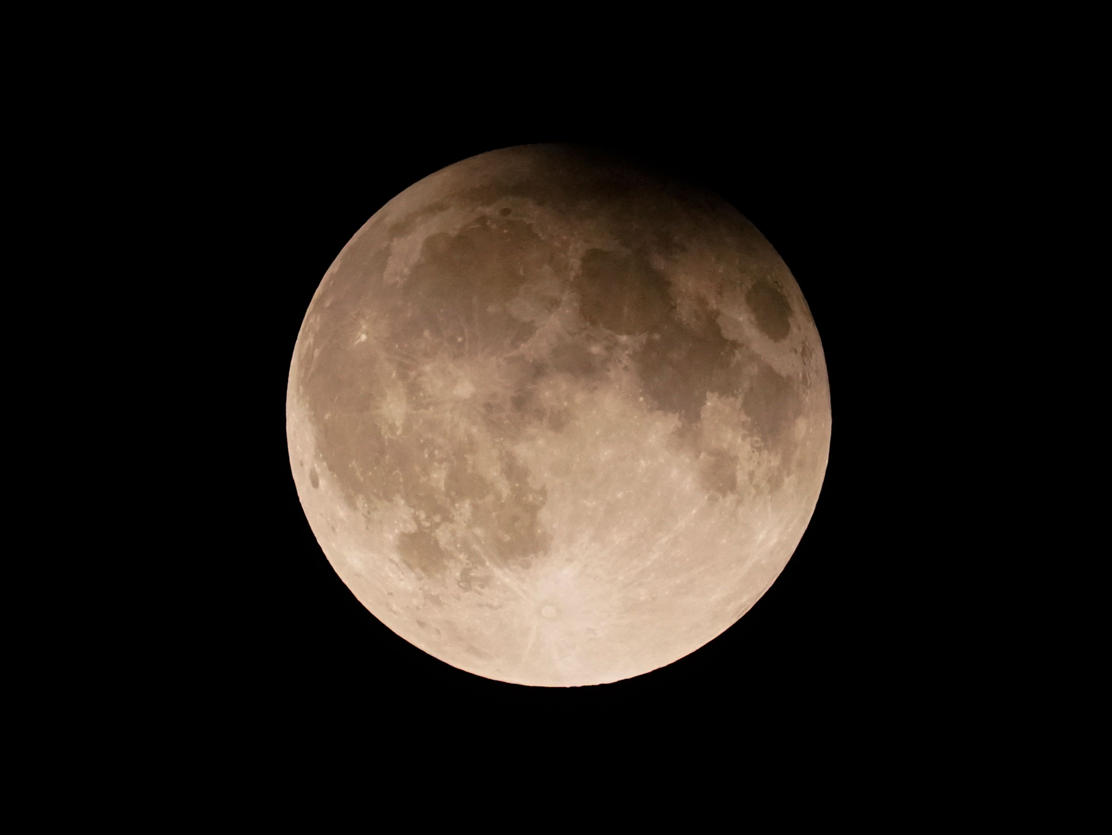 FILE - A supermoon with a partial lunar eclipse rises over Lake Michigan in Chicago, Tuesday, Sept. 17, 2024. (AP Photo/Kiichiro Sato, File)