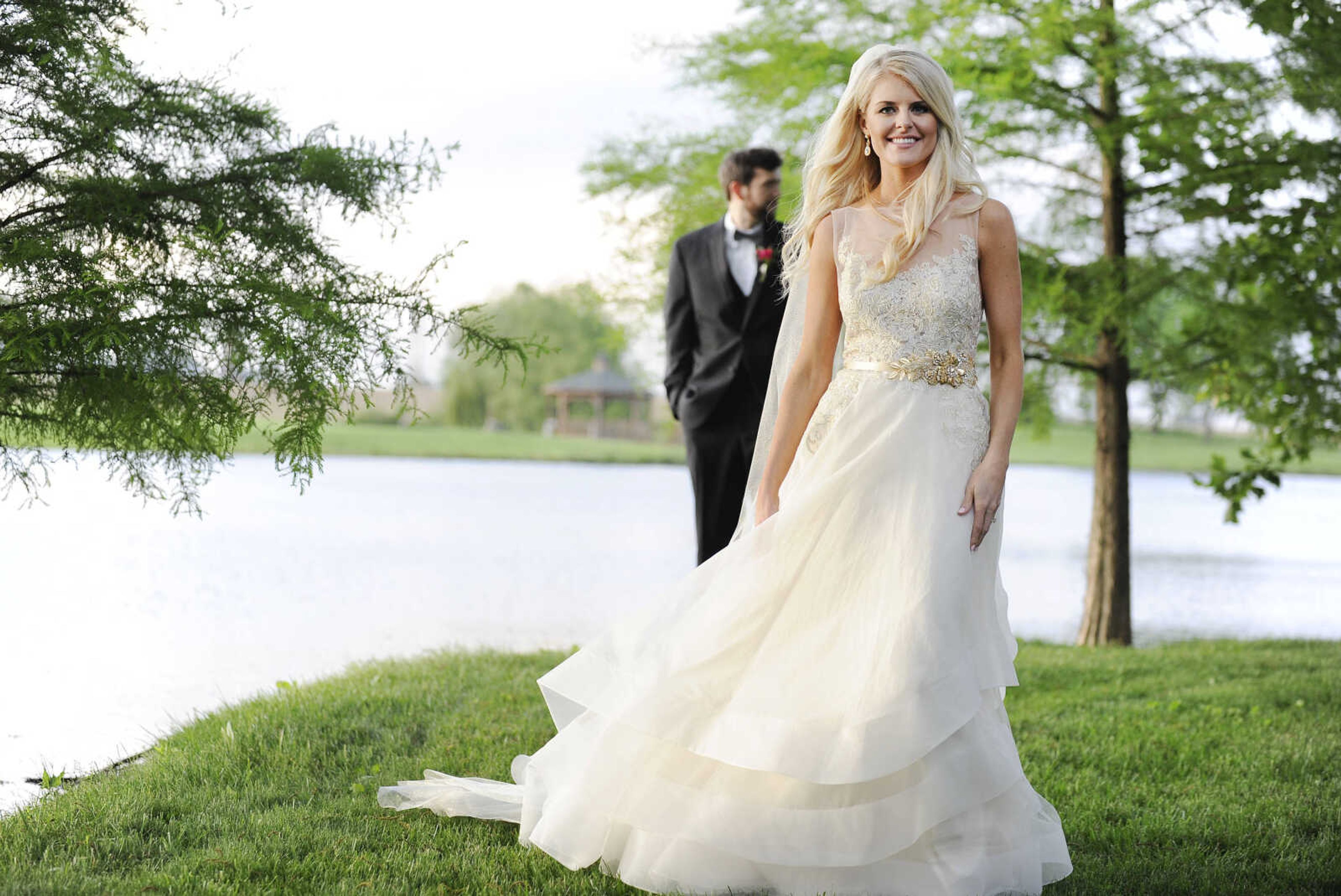 On Paige: This Tara Keely ballgown in ivory gold has an illusion scoop neckline, a V-back with cascading lace detail and an asymmetrical tiered skirt. The gown is accessorized with a glitzy gold belt and sparkle illusion cathedral-length veil, both by Lindsay Marie. Dress and accessories available at Magnolias Bridal Boutique in Cape Girardeau.

On Spencer: Manhattan slim fit tuxedo with solid black vest and black and white striped bow tie. Provided by Kim's Formal Wear and available at Garber's Men's Wear in Cape Girardeau.