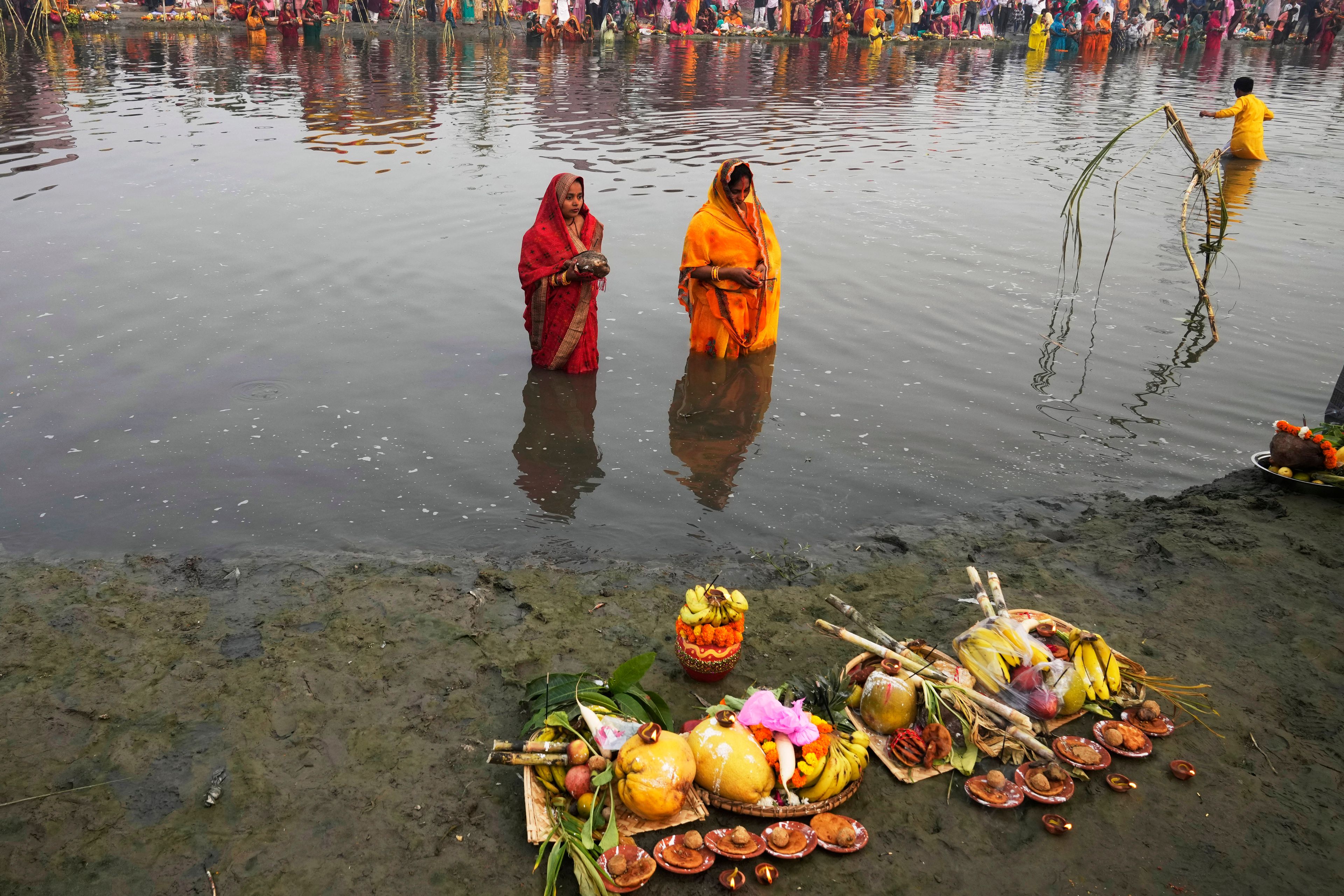 Women devotees offer prayers to the sun god on the banks of the river Yamuna during the Chhath festival in Noida, near New Delhi, India, Thursday, Nov. 7, 2024. (AP Photo/Manish Swarup)