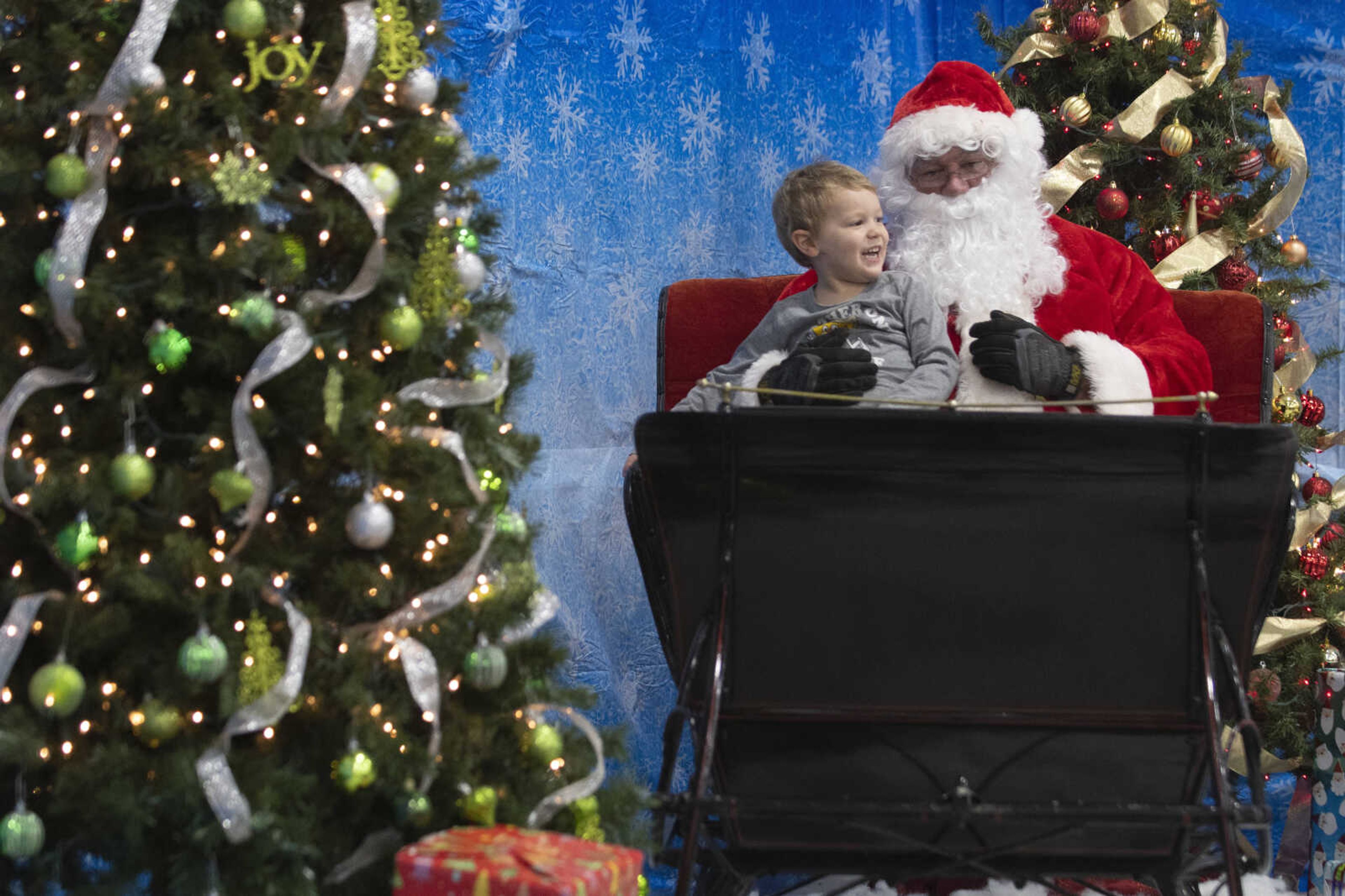 Camden Frank, 3, of Gordonville, meets with Santa Claus, portrayed by City of Cape Girardeau Parks &amp; Recreation parks division manager Brock Davis, during the Cape Parks &amp; Recreation Foundation's Breakfast with Santa event Saturday, Dec. 14, 2019, at the Osage Centre in Cape Girardeau.