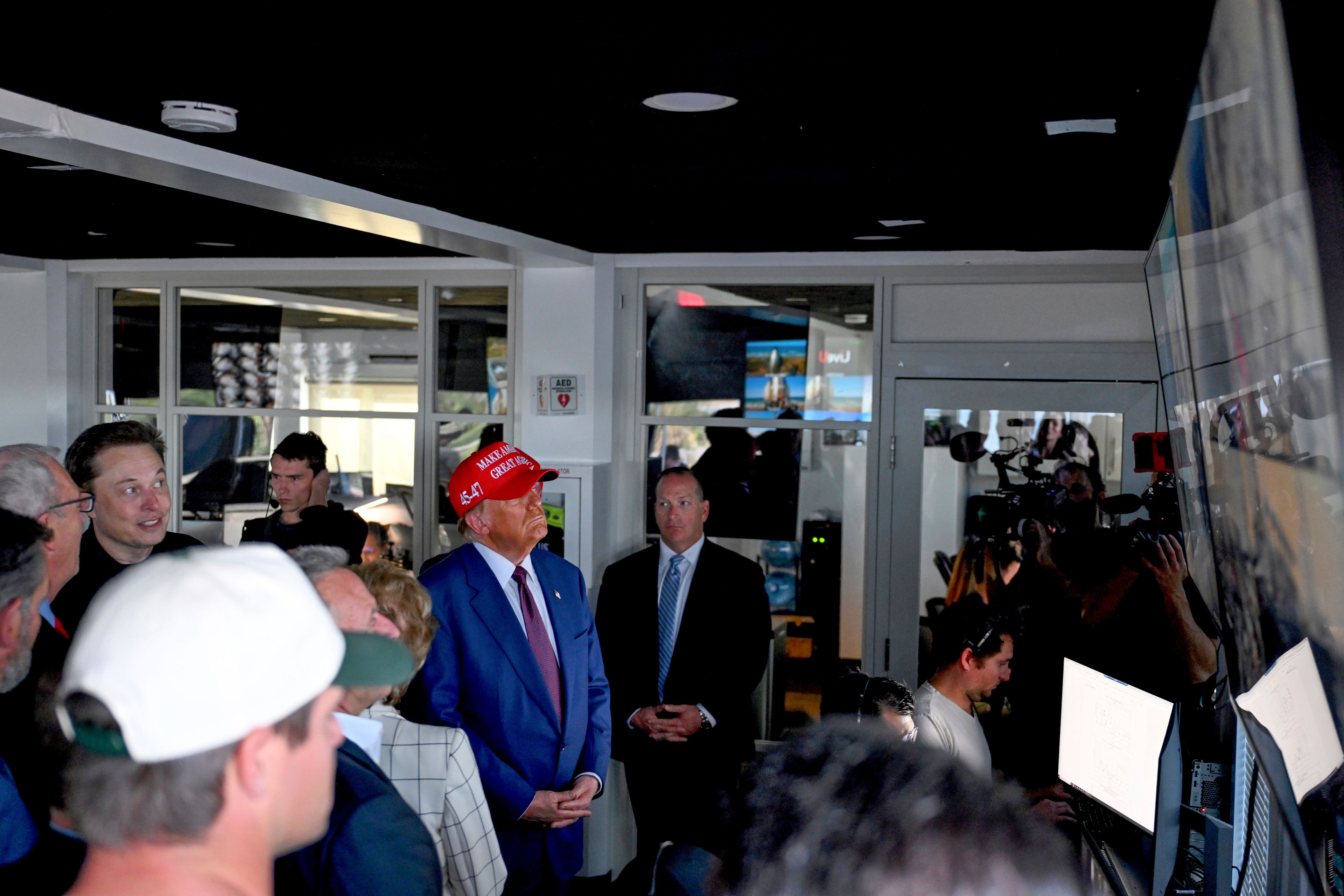 President-elect Donald Trump listens as Elon Musk explains the operations in the control room ahead of the launch of the sixth test flight of the SpaceX Starship rocket Tuesday, Nov. 19, 2024 in Brownsville, Texas. (Brandon Bell/Pool via AP)