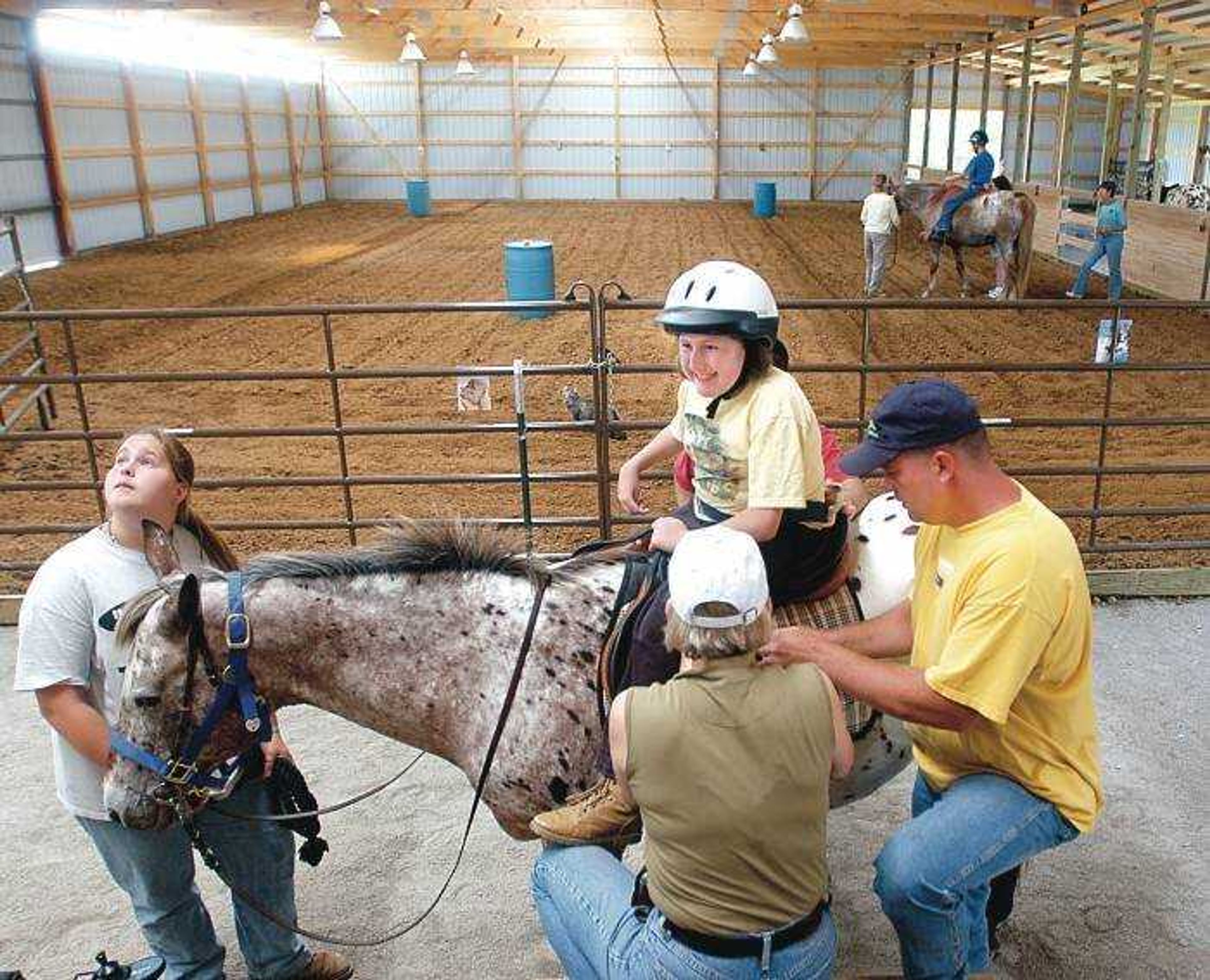 Becki Nation, 14 of jackson, smiled with excitement as she was strapped onto the saddle. Becki has been attending therapy at the Mississippi Valley Therapeutic Horsemanship in Oak Ridge for about 7 years. (Diane L. Wilson)