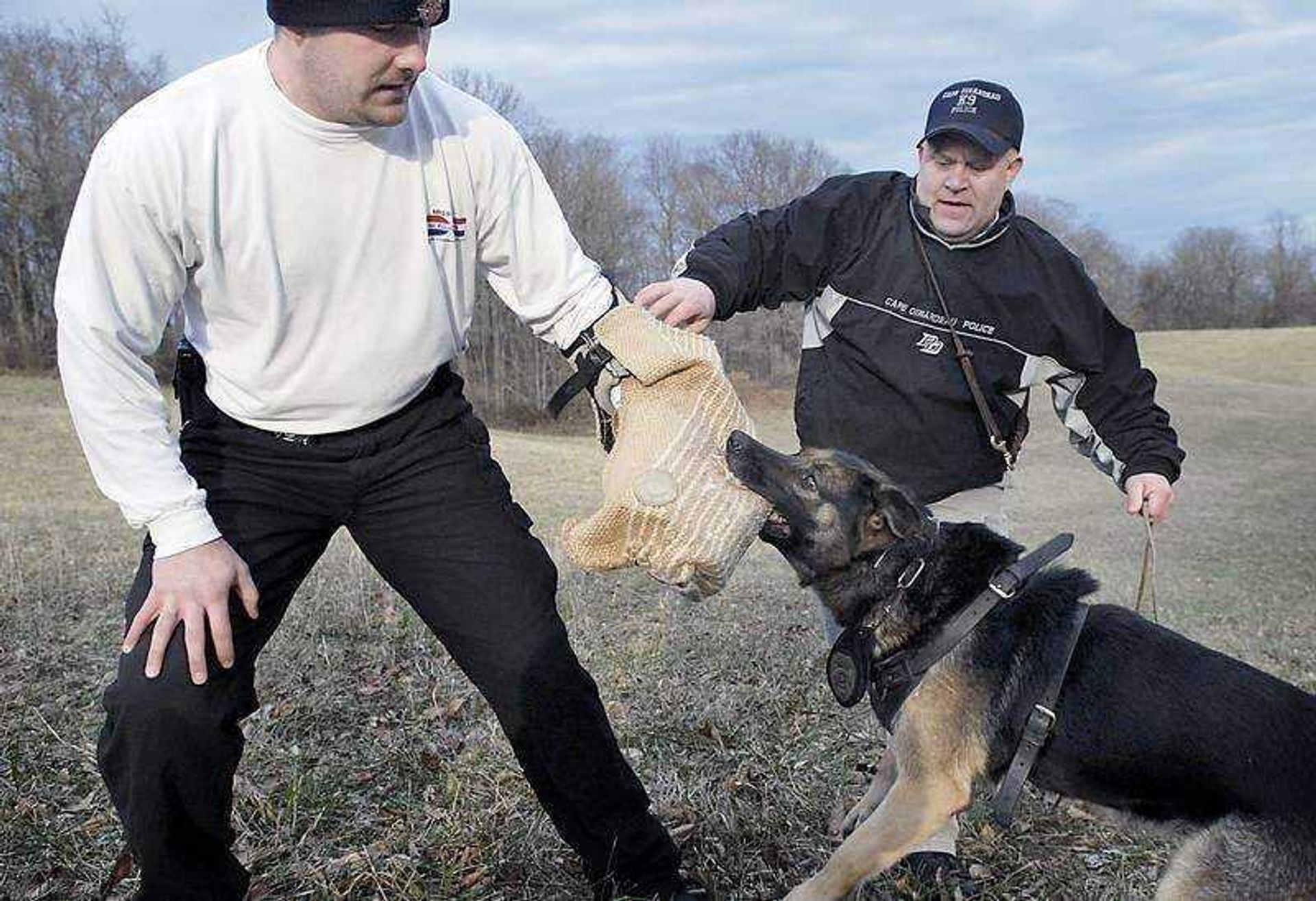 KIT DOYLE ~ kdoyle@semissourian.comJeff Bourbon, left, played the suspect for a tracking and biting drill for Roy Rahn's dog, Bolo, on Jan. 28 near Cape Girardeau during a training session for the Cape Girardeau Police Department K-9 Unit. Bolo, who is 8 years old, is due for retirement as soon as a replacement is bought.